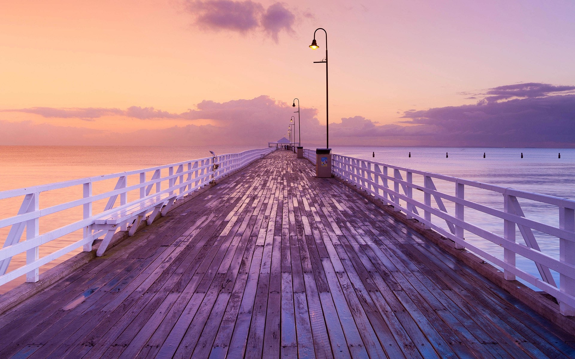 Wooden pier with white railings at sunset HD Wallpaper