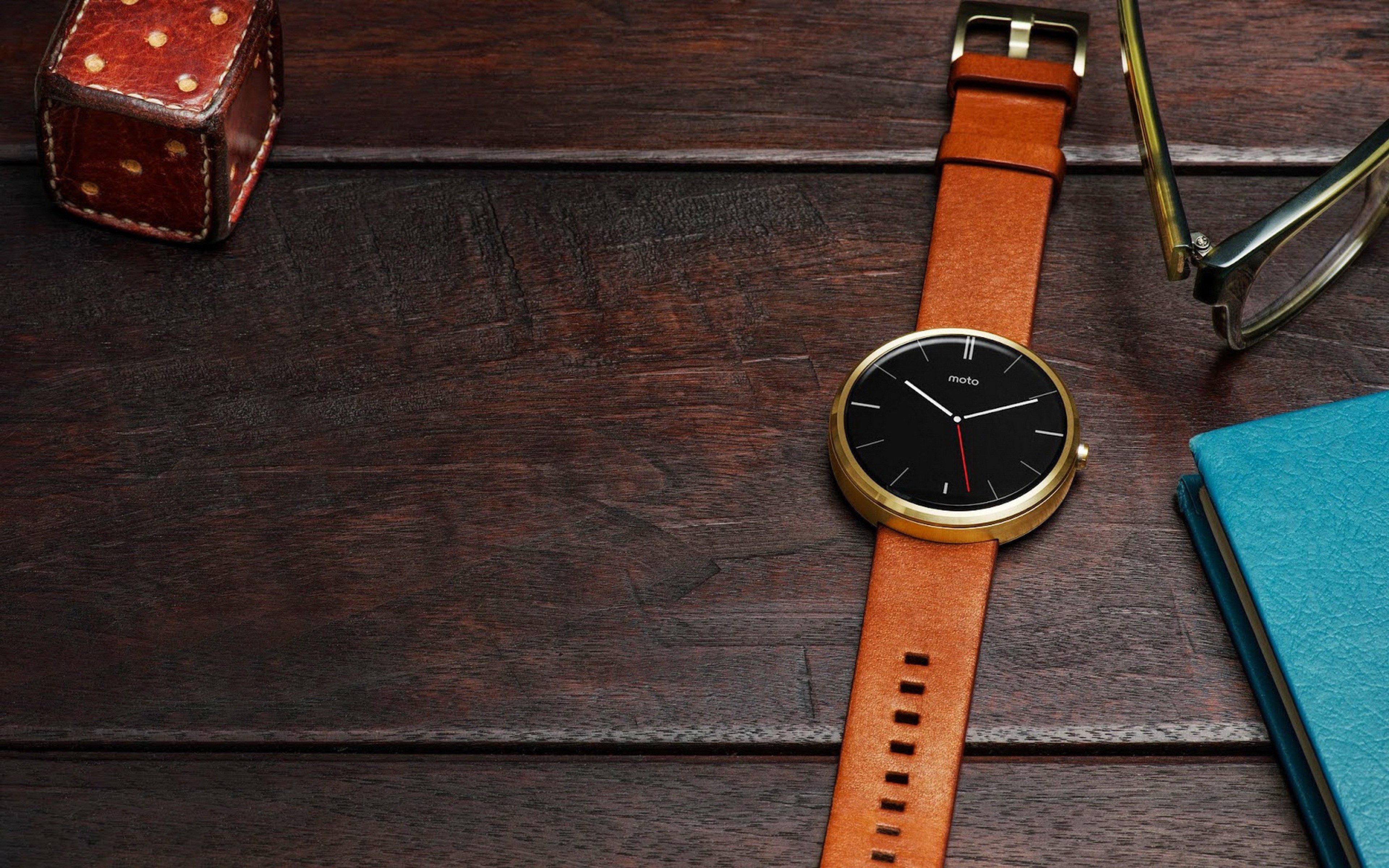 Motorola smartwatch with leather strap on wooden table HD Wallpaper
