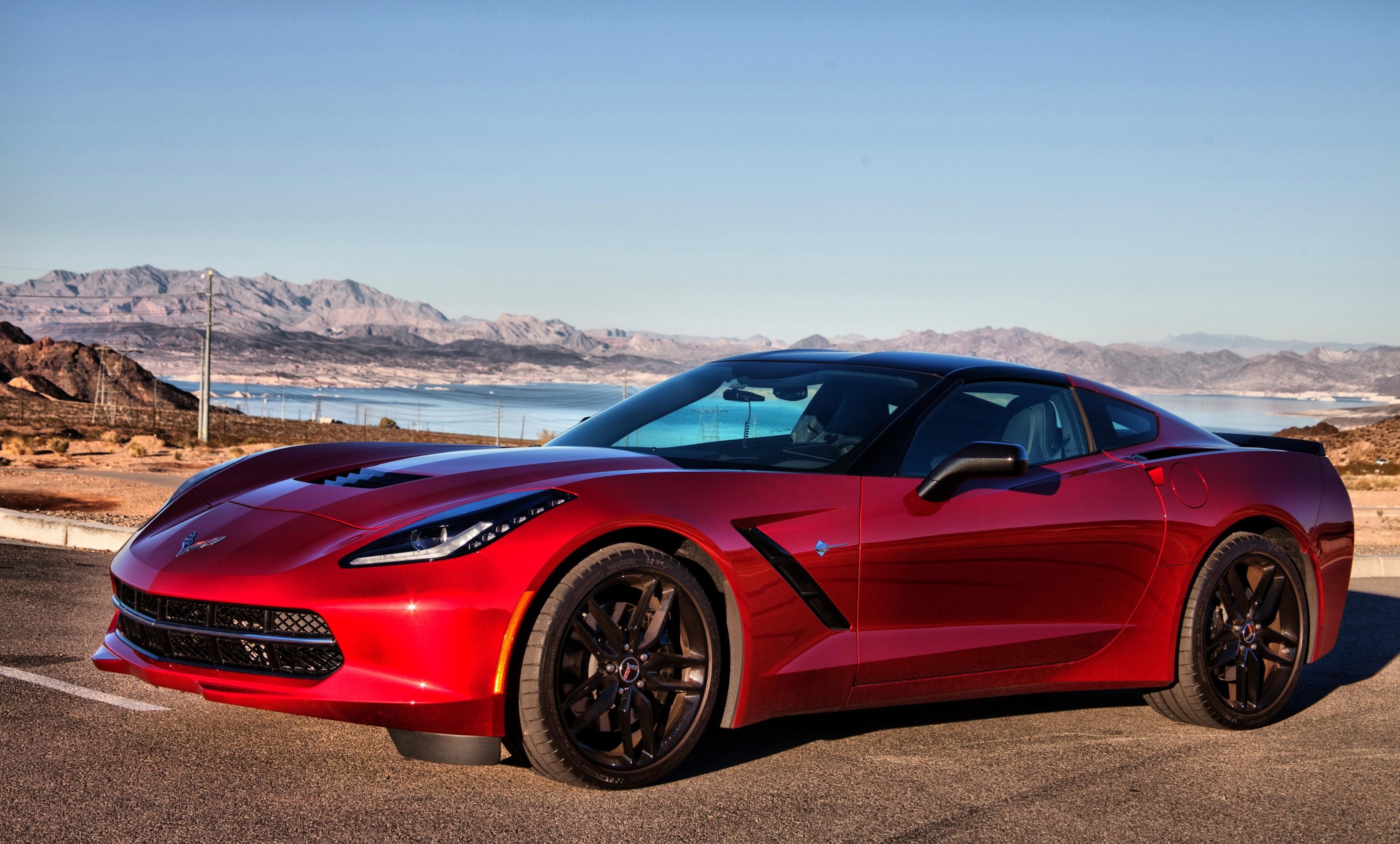 Red Chevrolet Corvette C7 parked by a lake HD Wallpaper