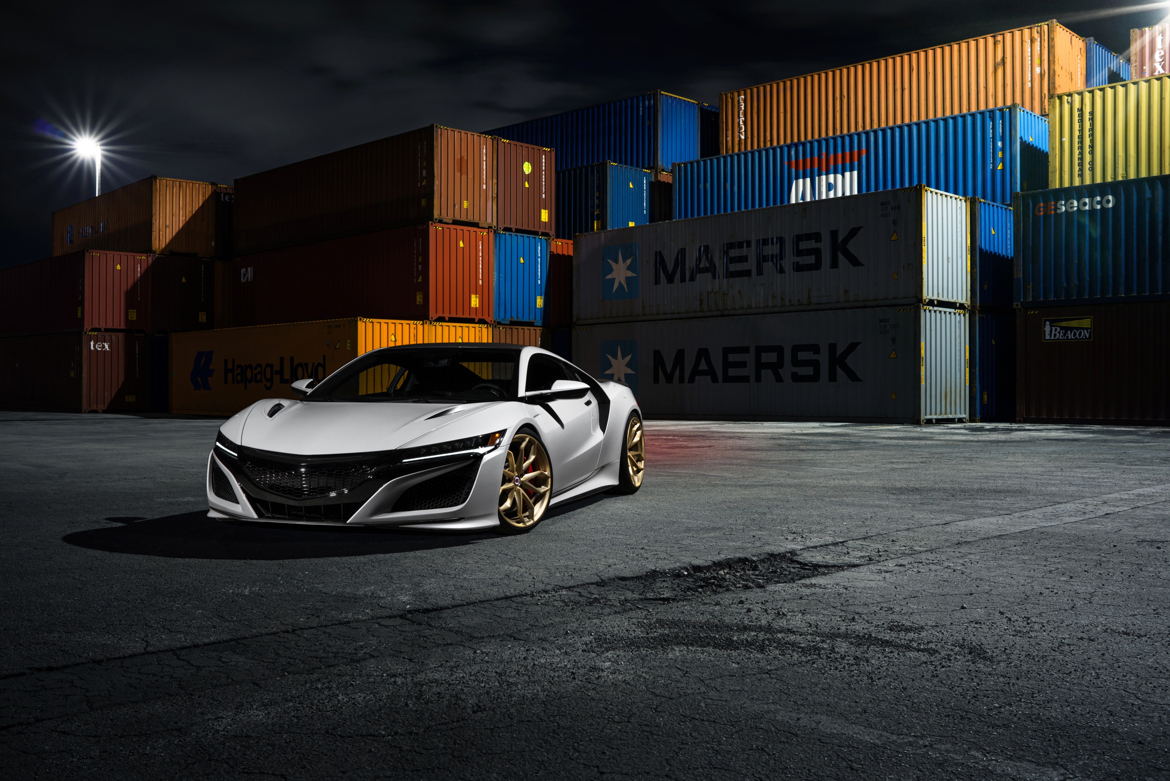 White Acura NSX with gold wheels in shipping yard HD Wallpaper