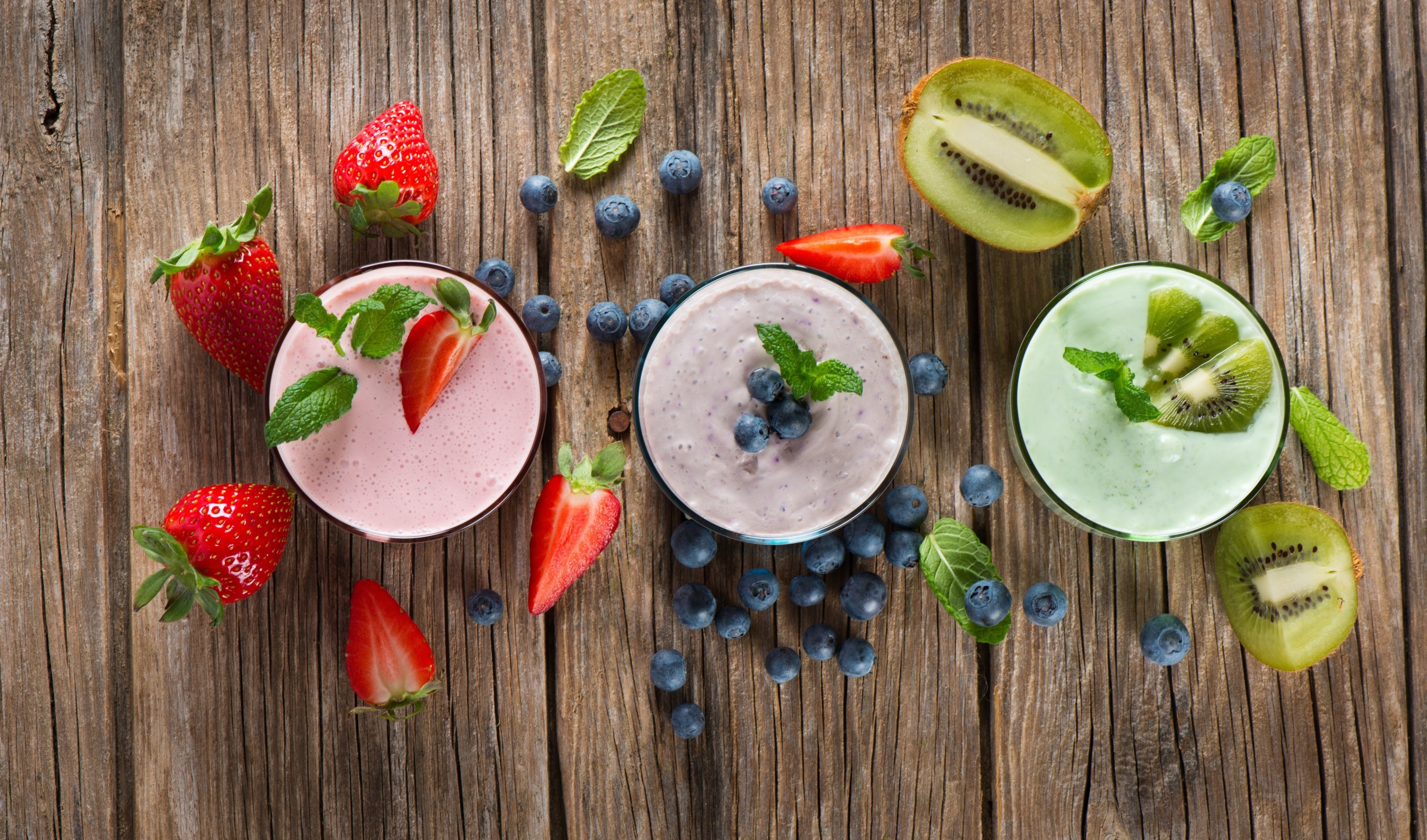 Smoothies with Strawberries, Blueberries, and Kiwi on Wood HD Wallpaper