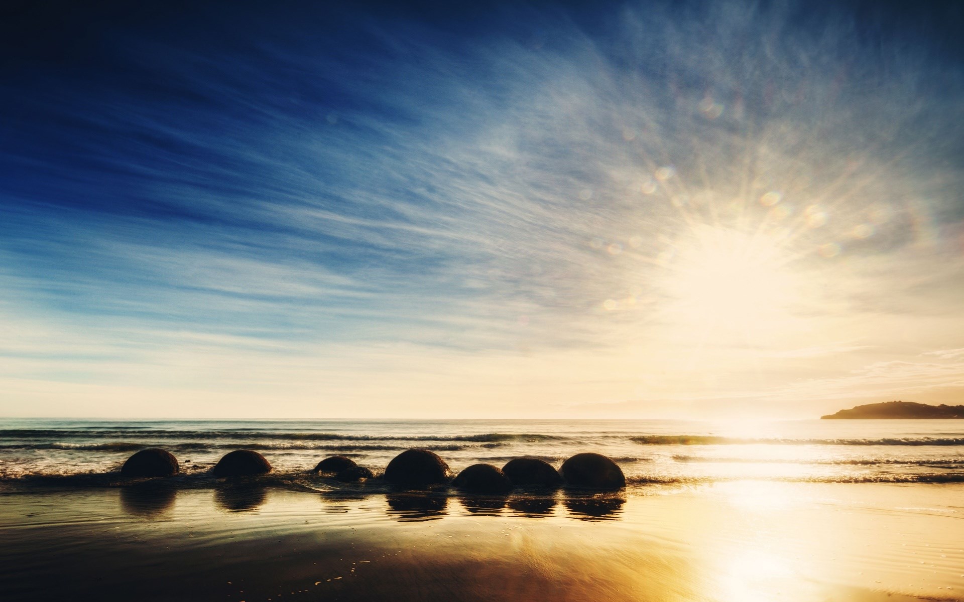 Moeraki Boulders on a beach at sunrise HD Wallpaper