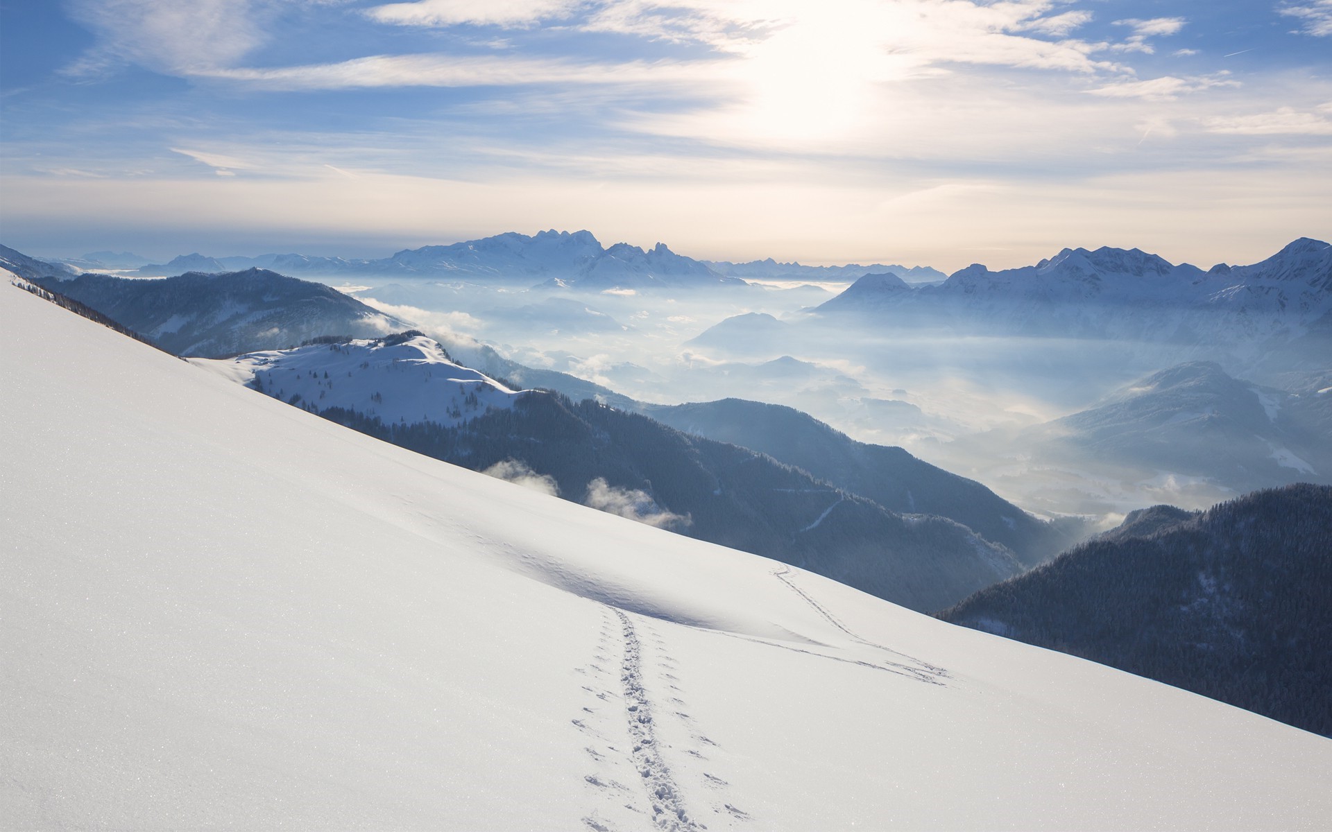 Snowy mountain landscape with mist and blue sky HD Wallpaper