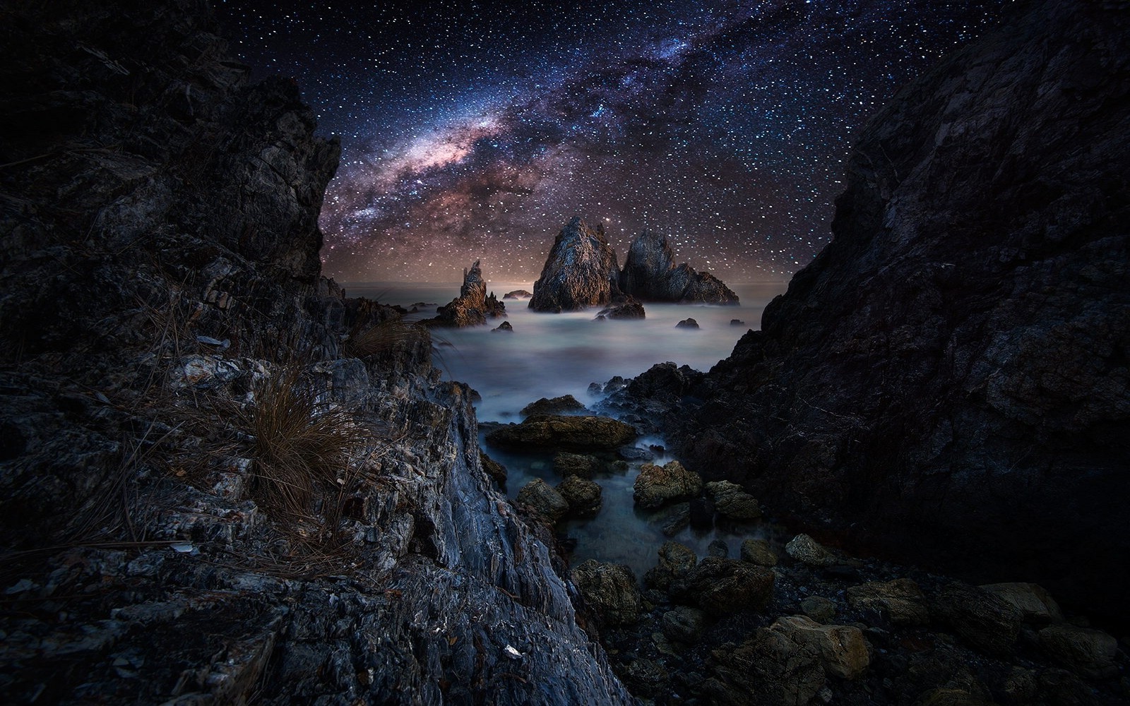 Starry Night Sky Over Rocky Coastal Tunnel HD Wallpaper