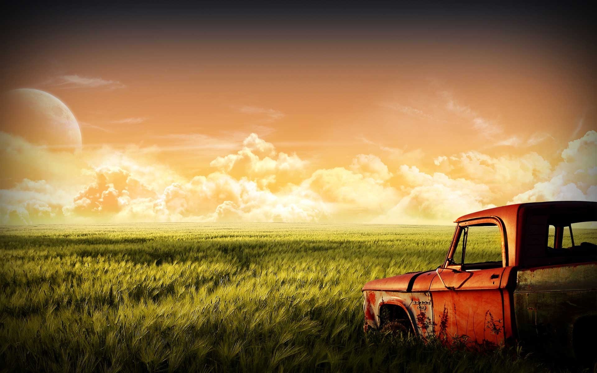 Rusty truck in a field with a large moon HD Wallpaper