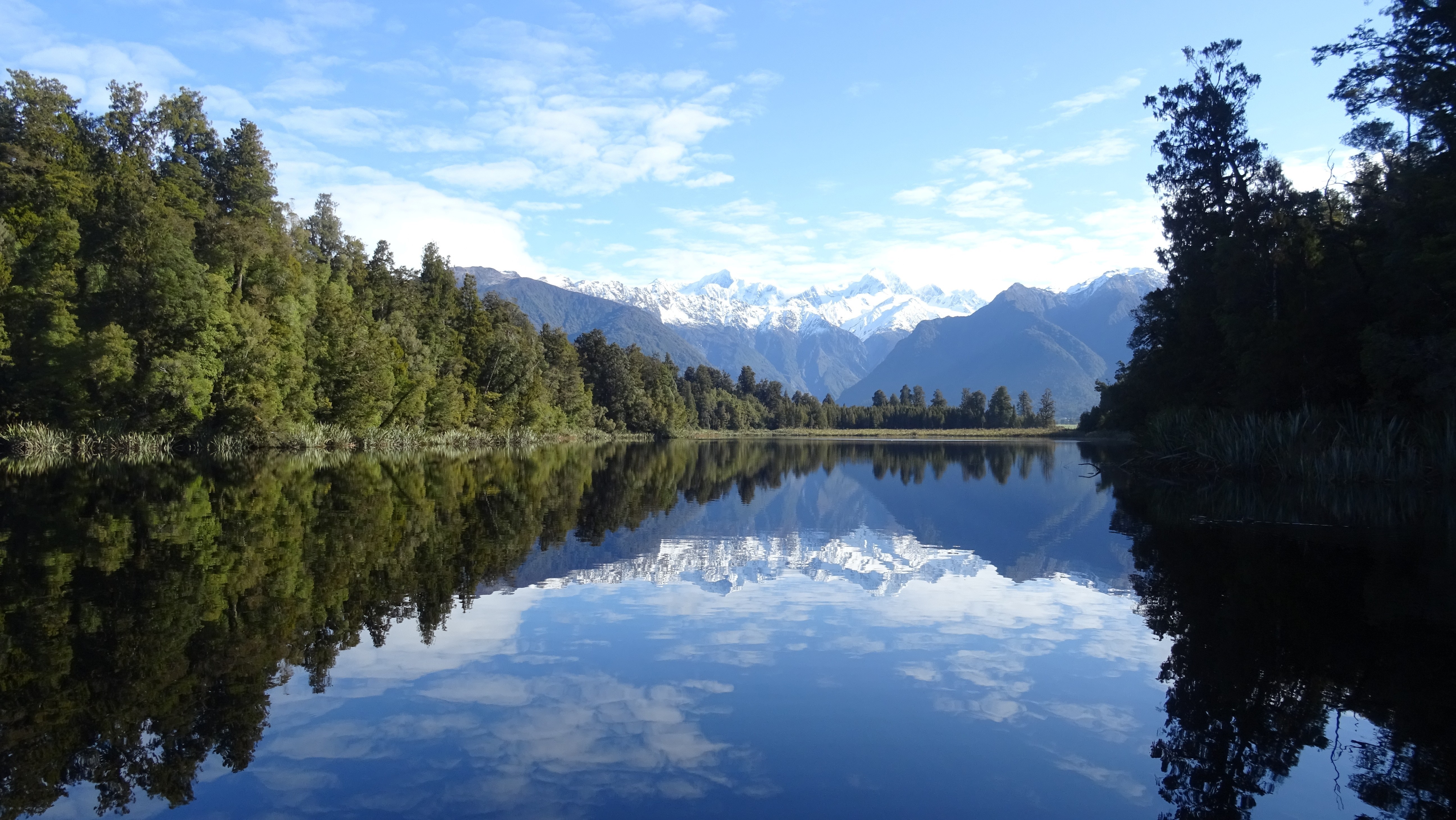 Lake Matheson with snowy peaks and forest reflection HD Wallpaper