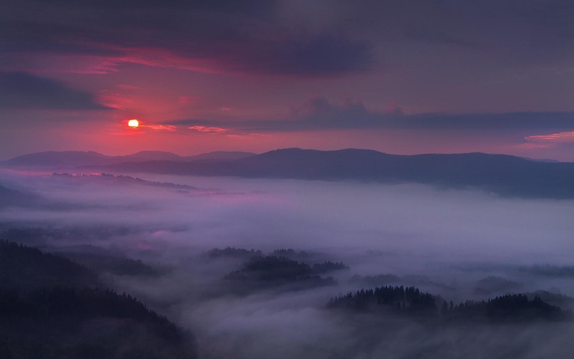 Purple misty mountains at sunset with sun and clouds HD Wallpaper