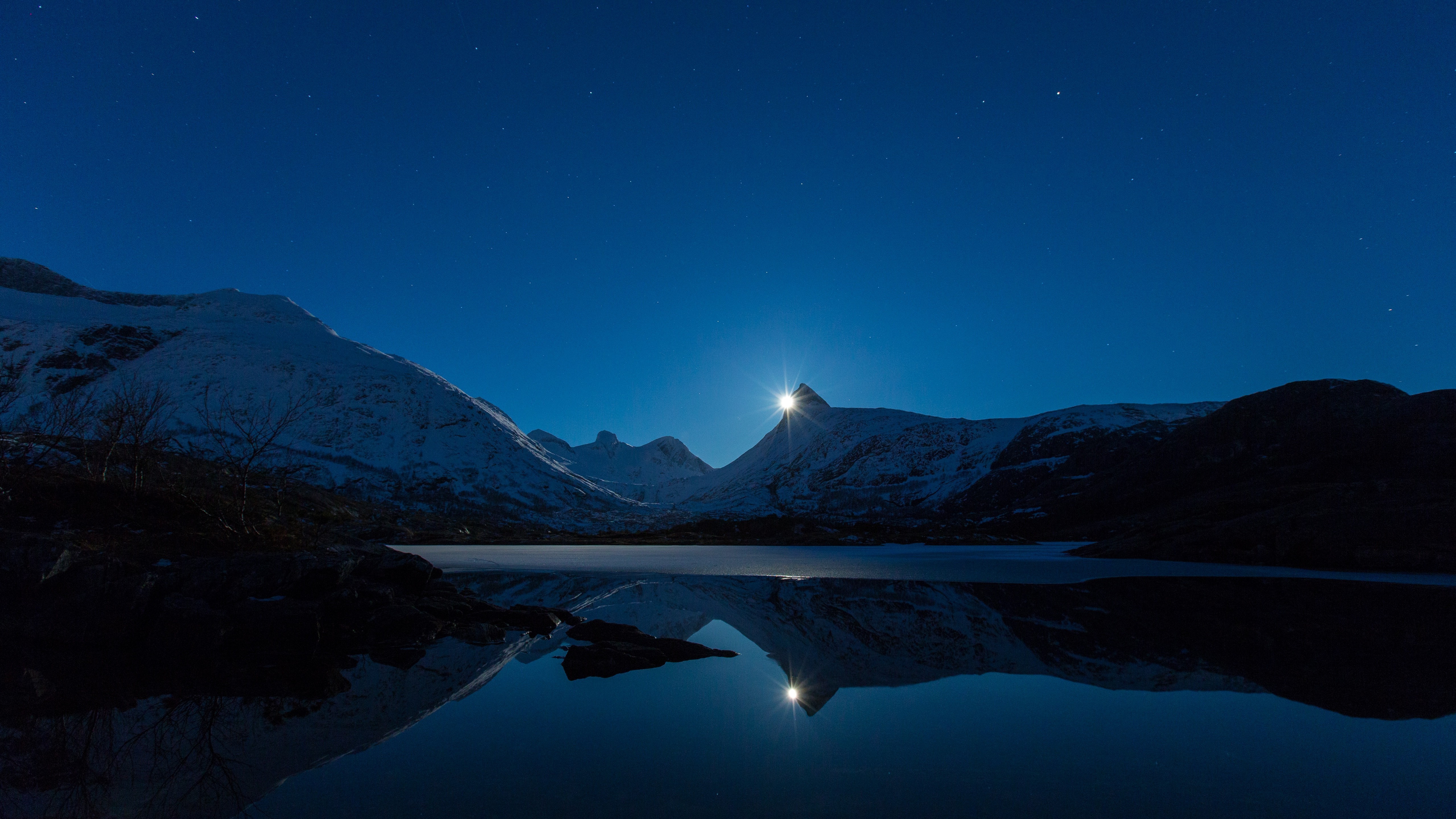 Moonlit snowy mountains reflected in a lake in Norway HD Wallpaper