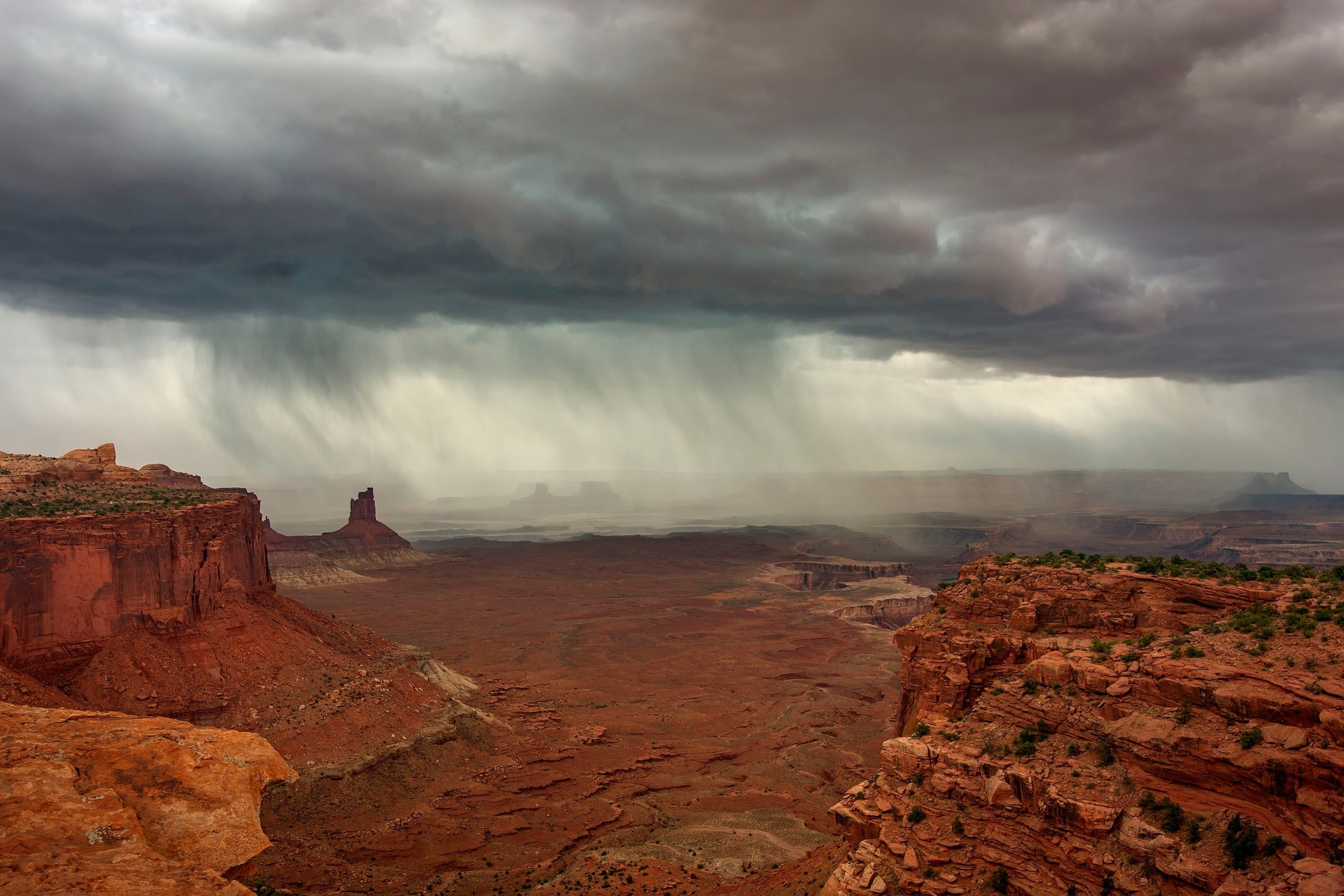 Stormy sky over a desert canyon landscape HD Wallpaper