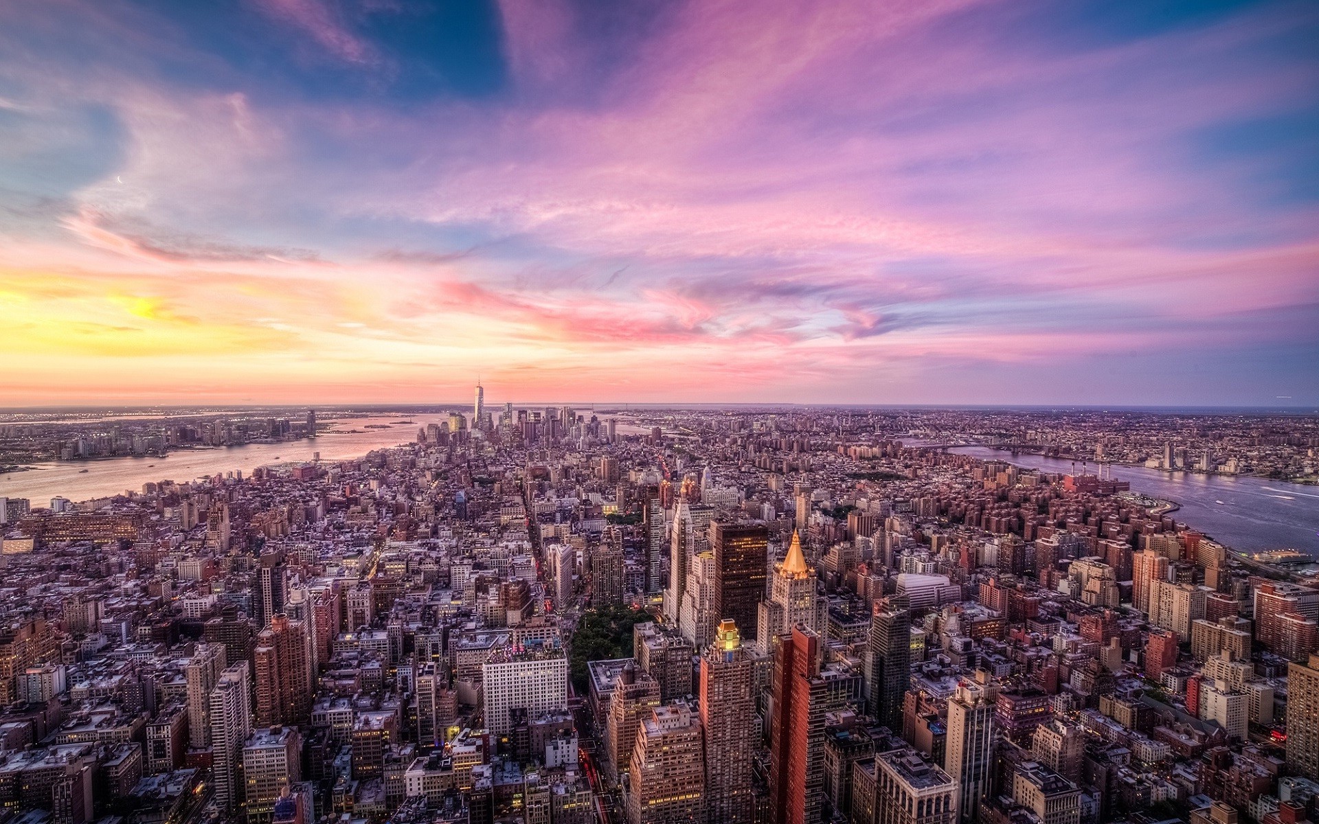 New York City skyline at sunset with colorful clouds HD Wallpaper