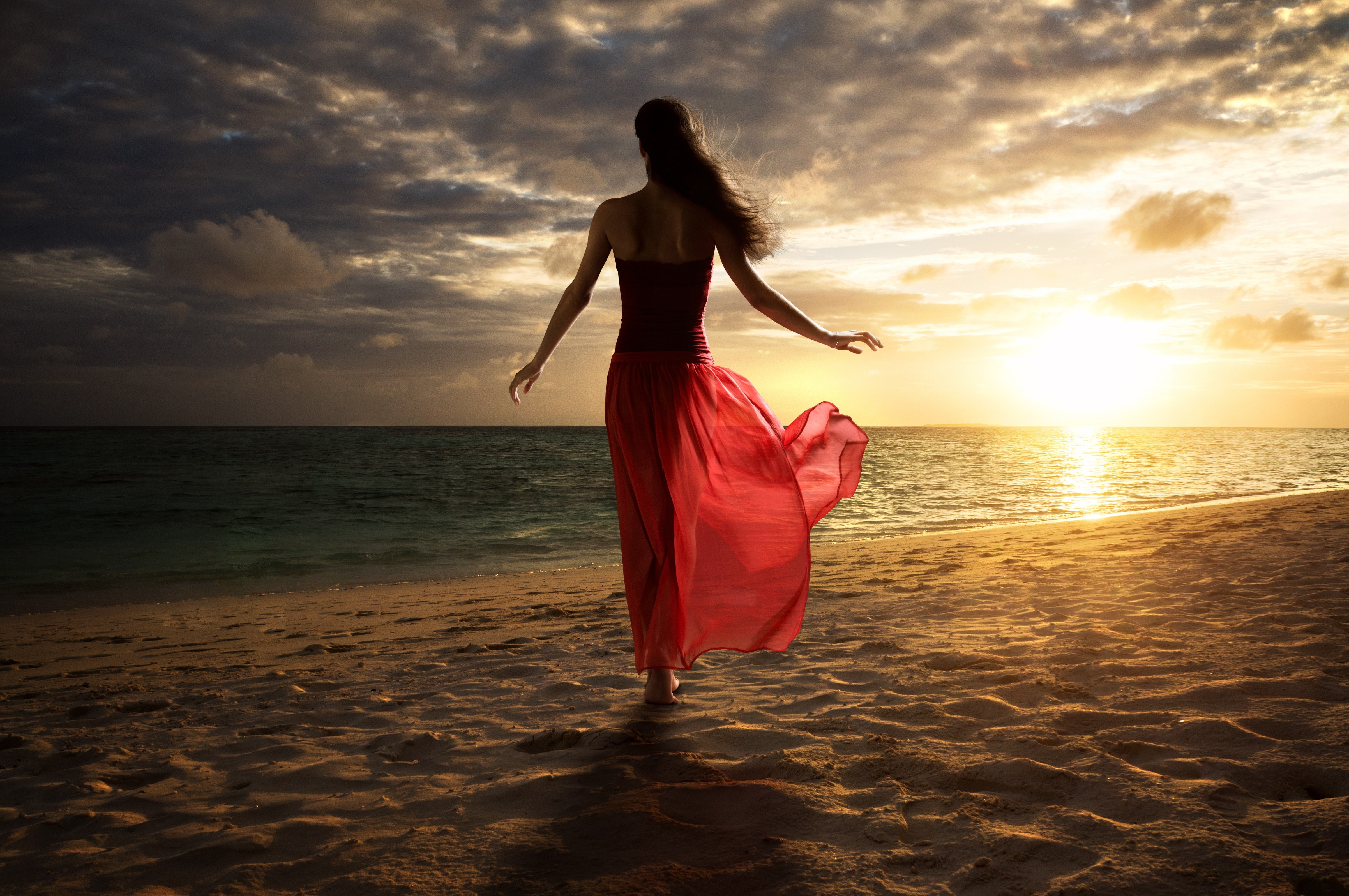 Woman in red dress on beach at sunset HD Wallpaper