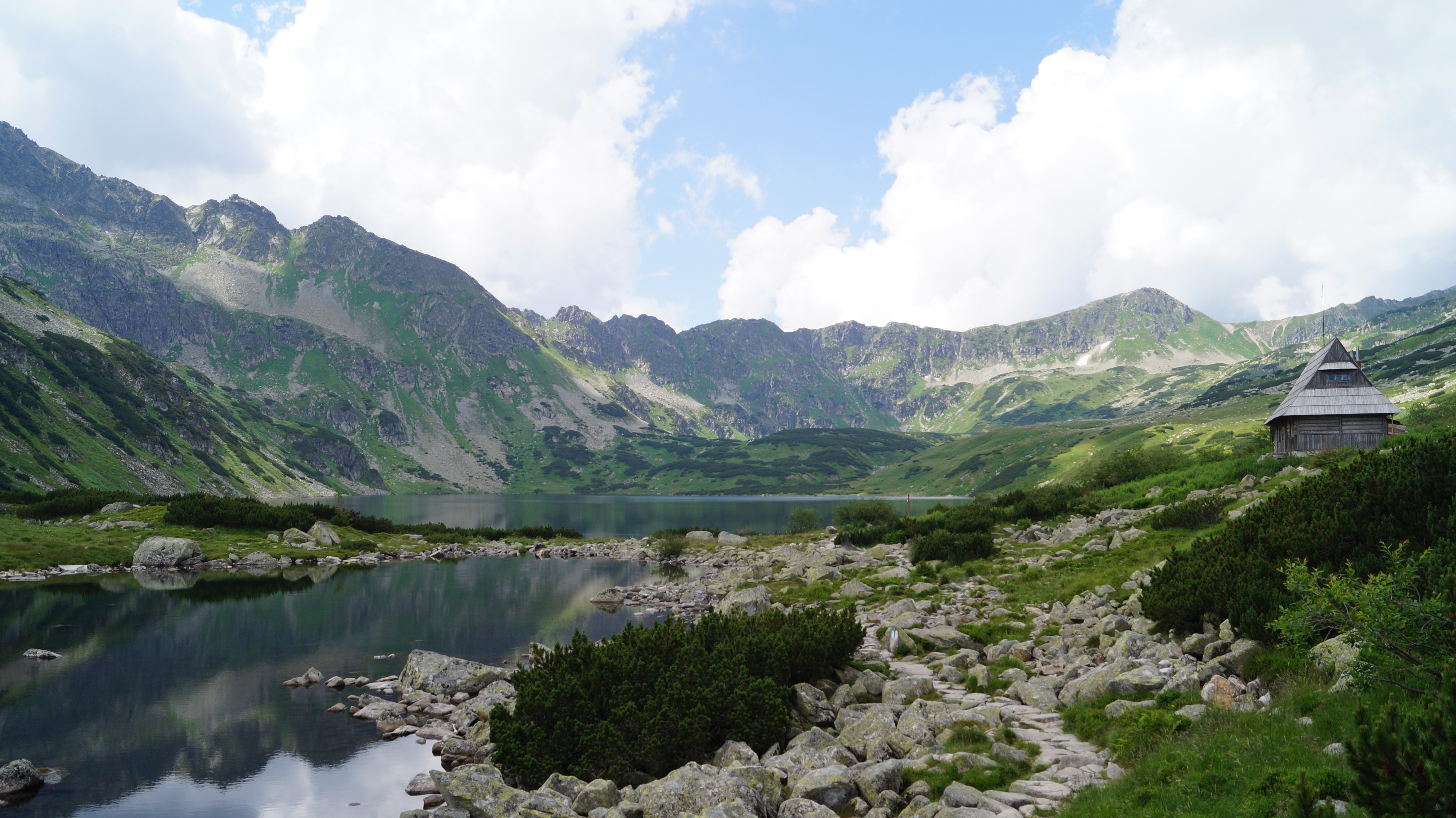 Mountain lake with a wooden cabin in the Tatra Mountains, Poland HD Wallpaper