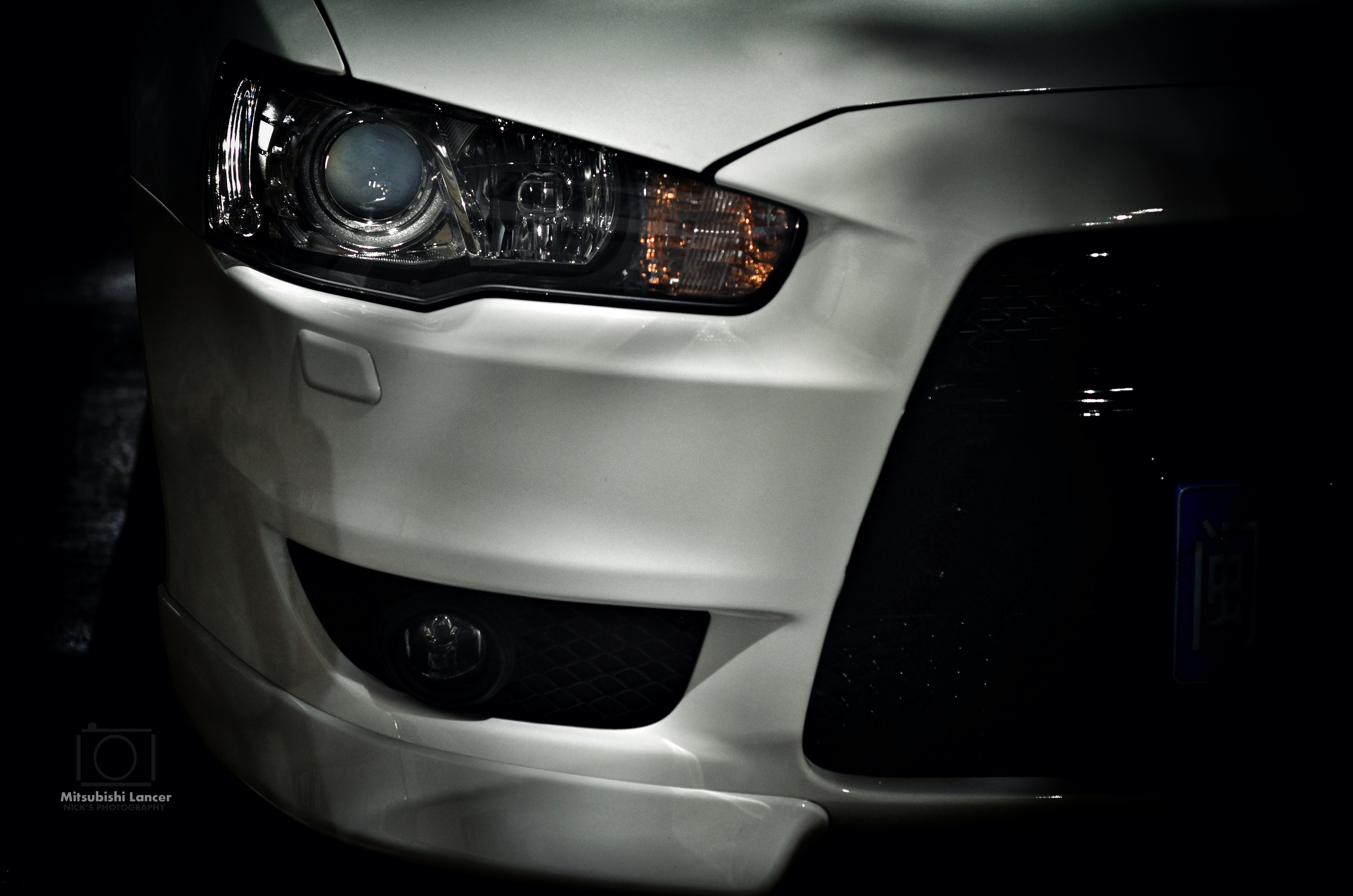 Front view of a white Mitsubishi Lancer HD Wallpaper