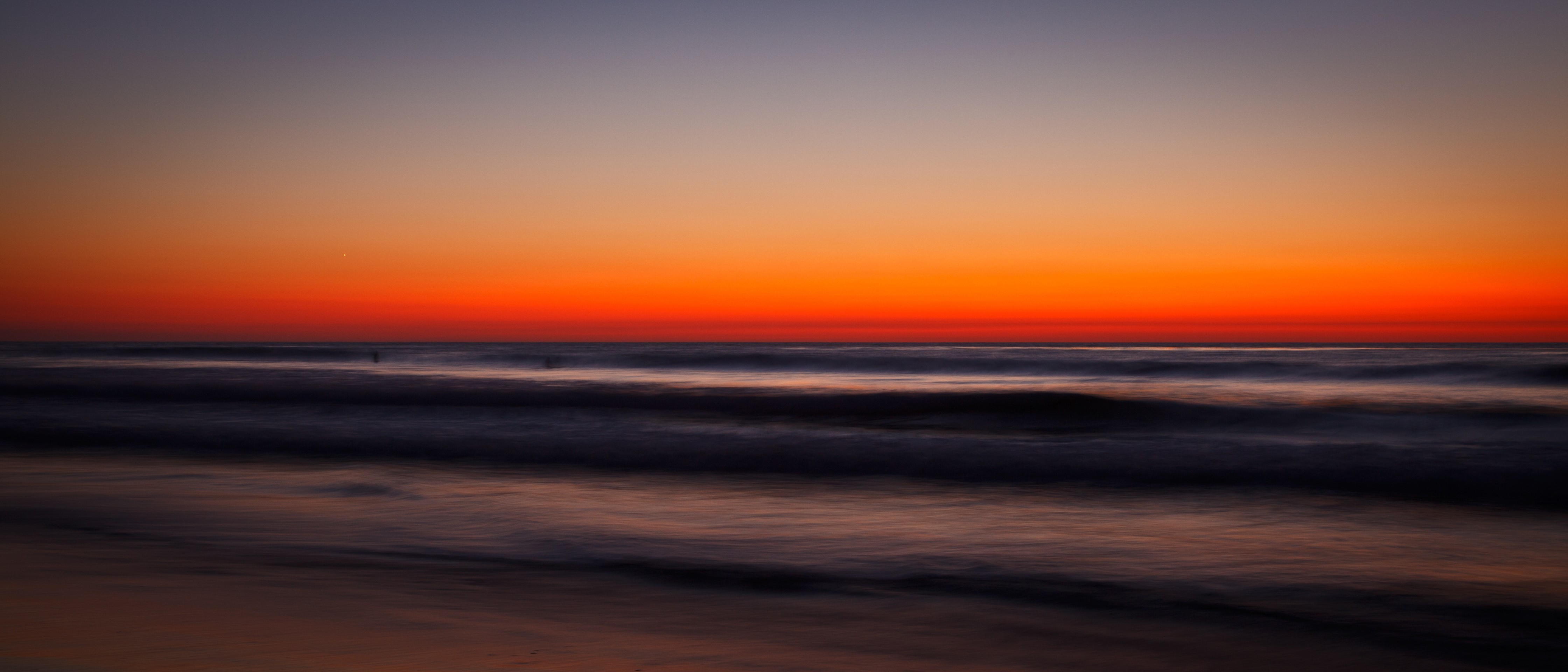 Sunset over the ocean with long exposure waves HD Wallpaper