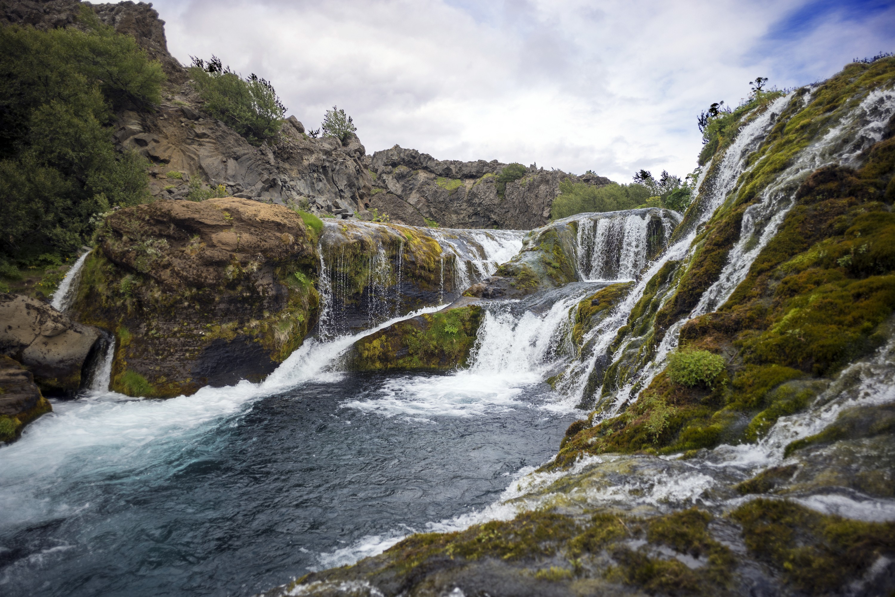 Multiple Waterfalls Flowing into a Serene River in Iceland HD Wallpaper