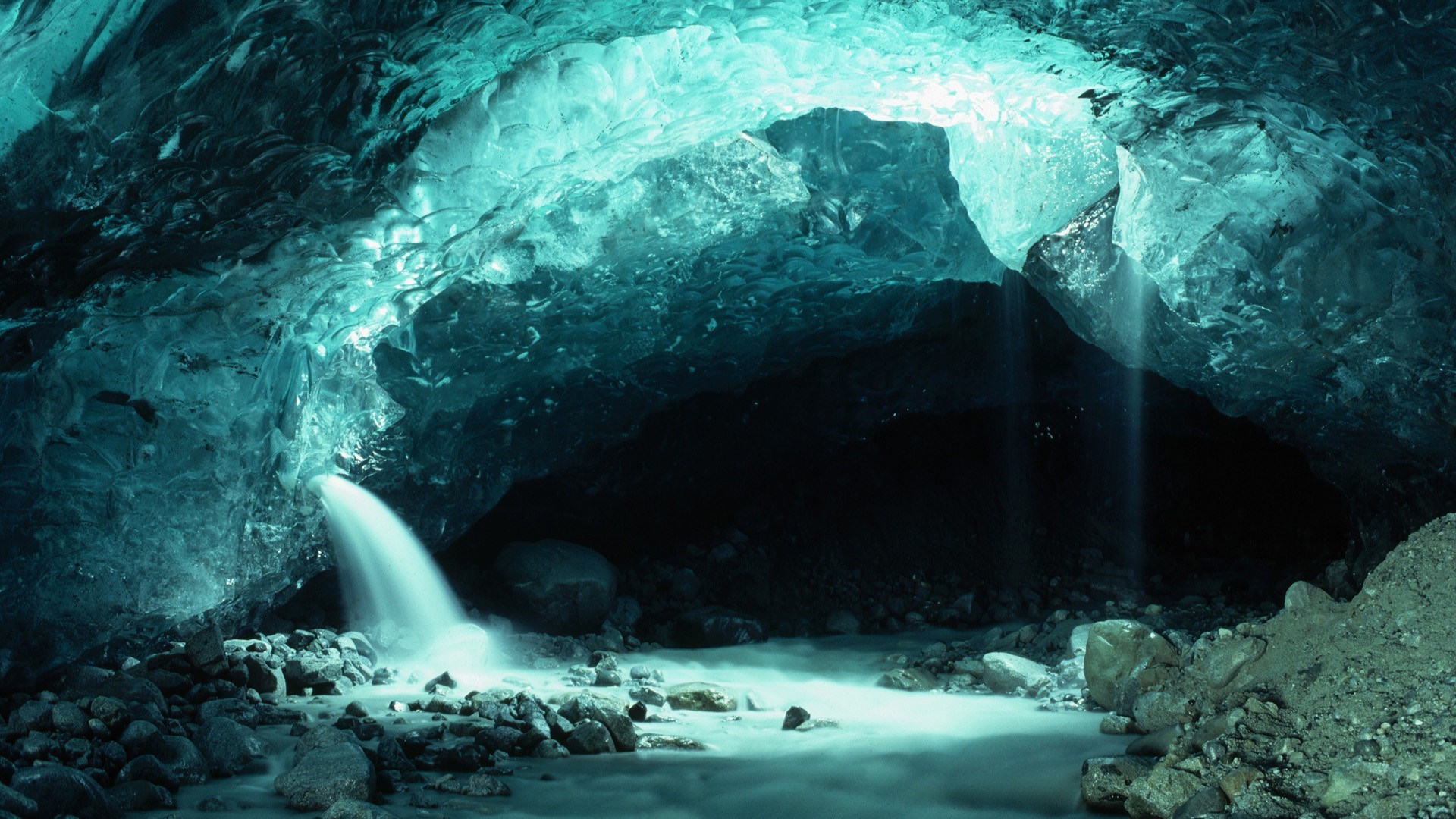 Ice cave with waterfall and stream HD Wallpaper