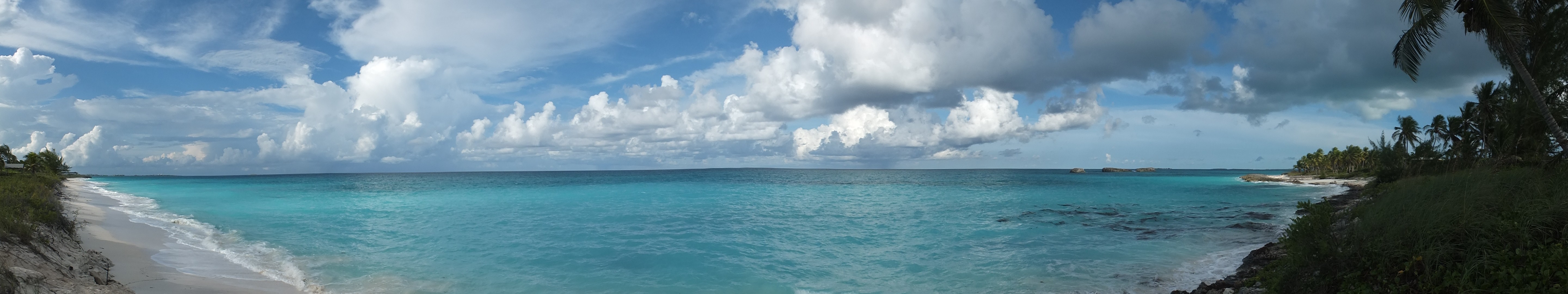Panoramic view of a tropical beach with turquoise water and clouds HD Wallpaper