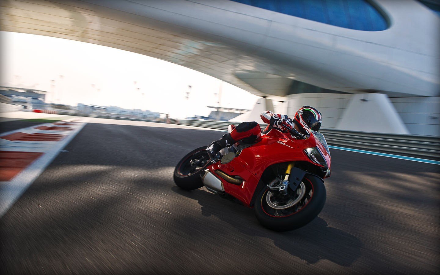 Red Ducati 1199 motorcycle on a race track HD Wallpaper