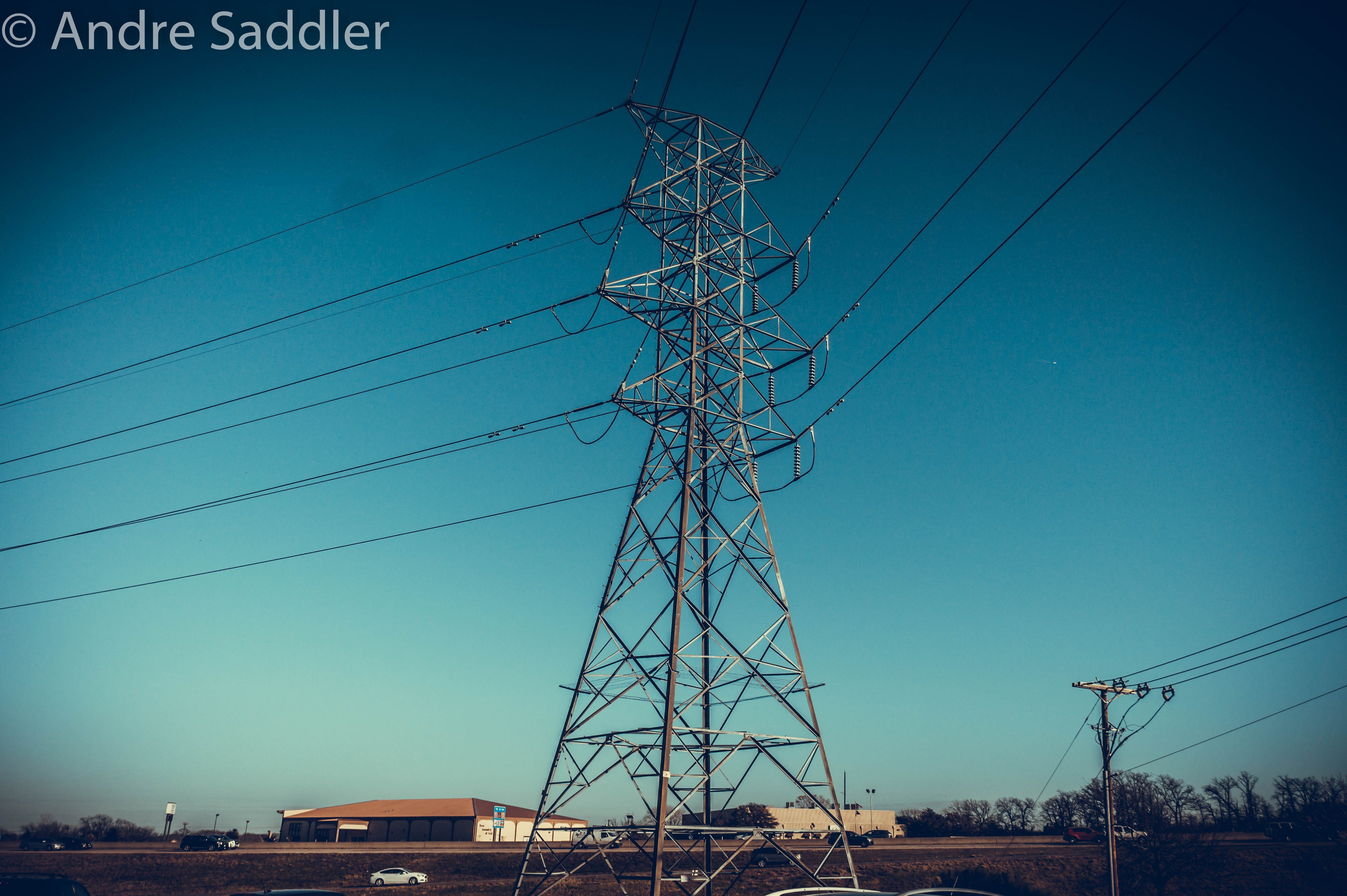 Power lines and transmission tower against blue sky HD Wallpaper