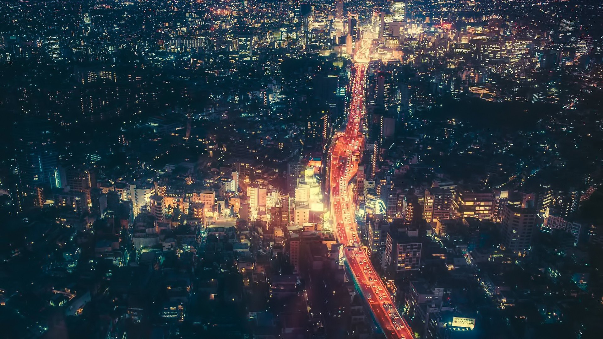 Aerial view of Tokyo at night with illuminated highway HD Wallpaper
