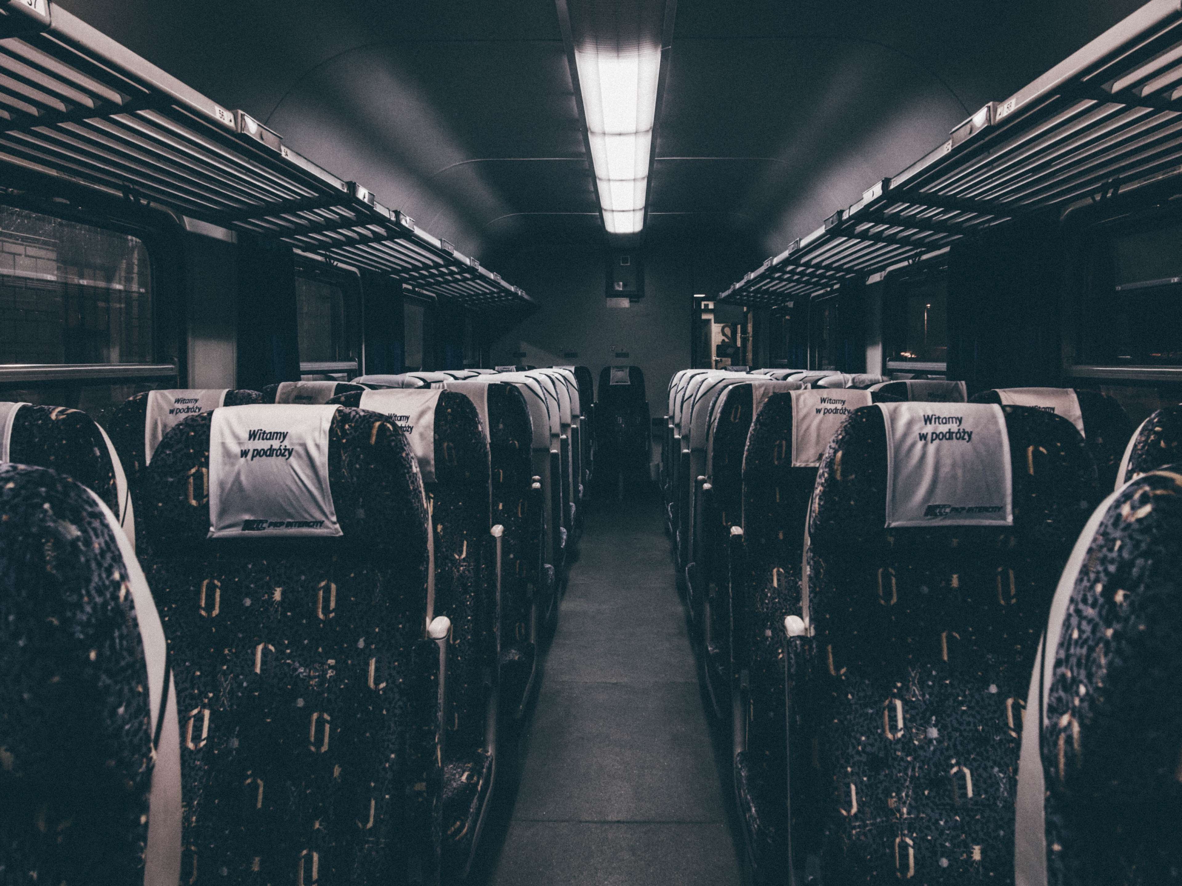 Interior of a train carriage with seats HD Wallpaper