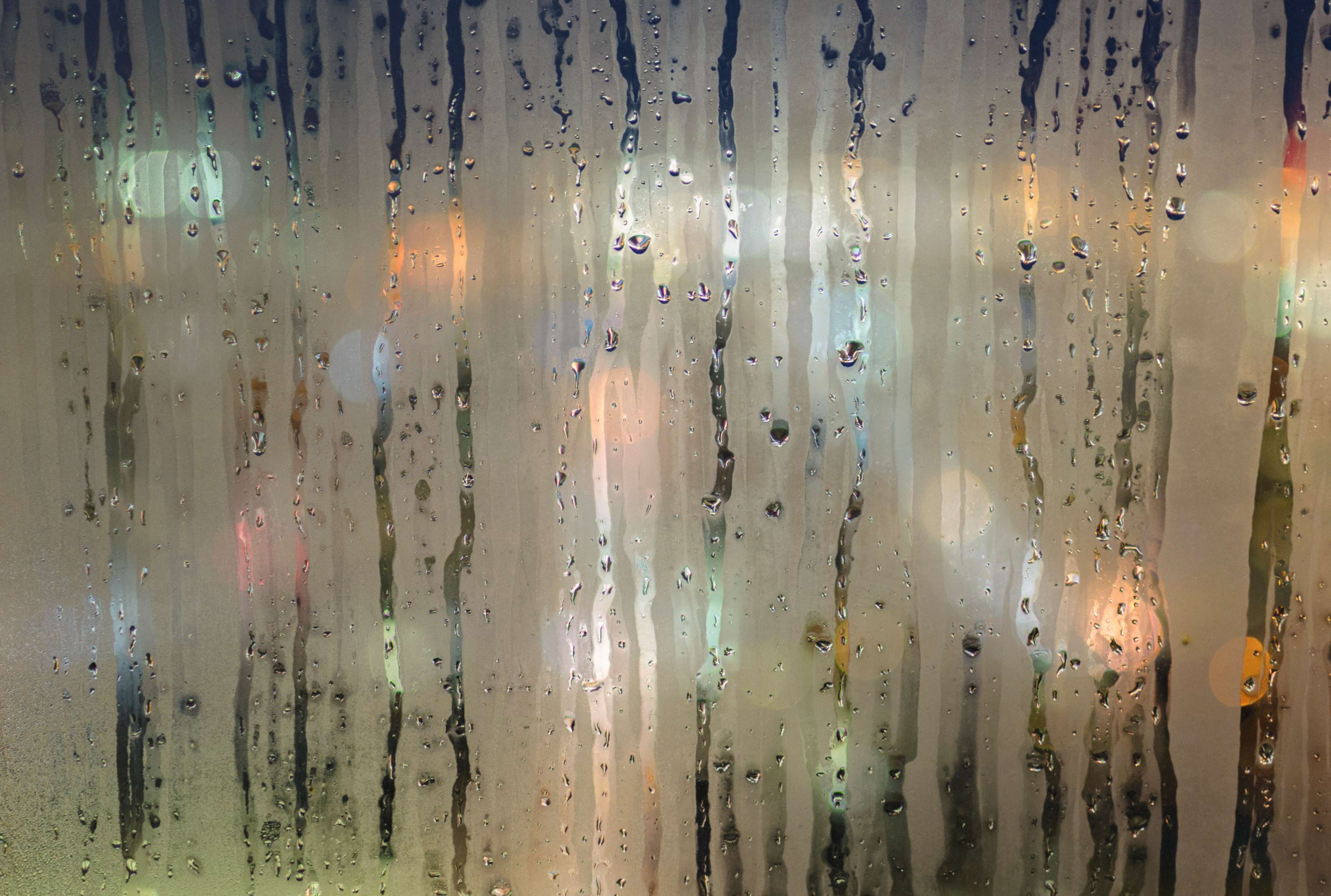 Raindrops on a foggy window with city lights HD Wallpaper