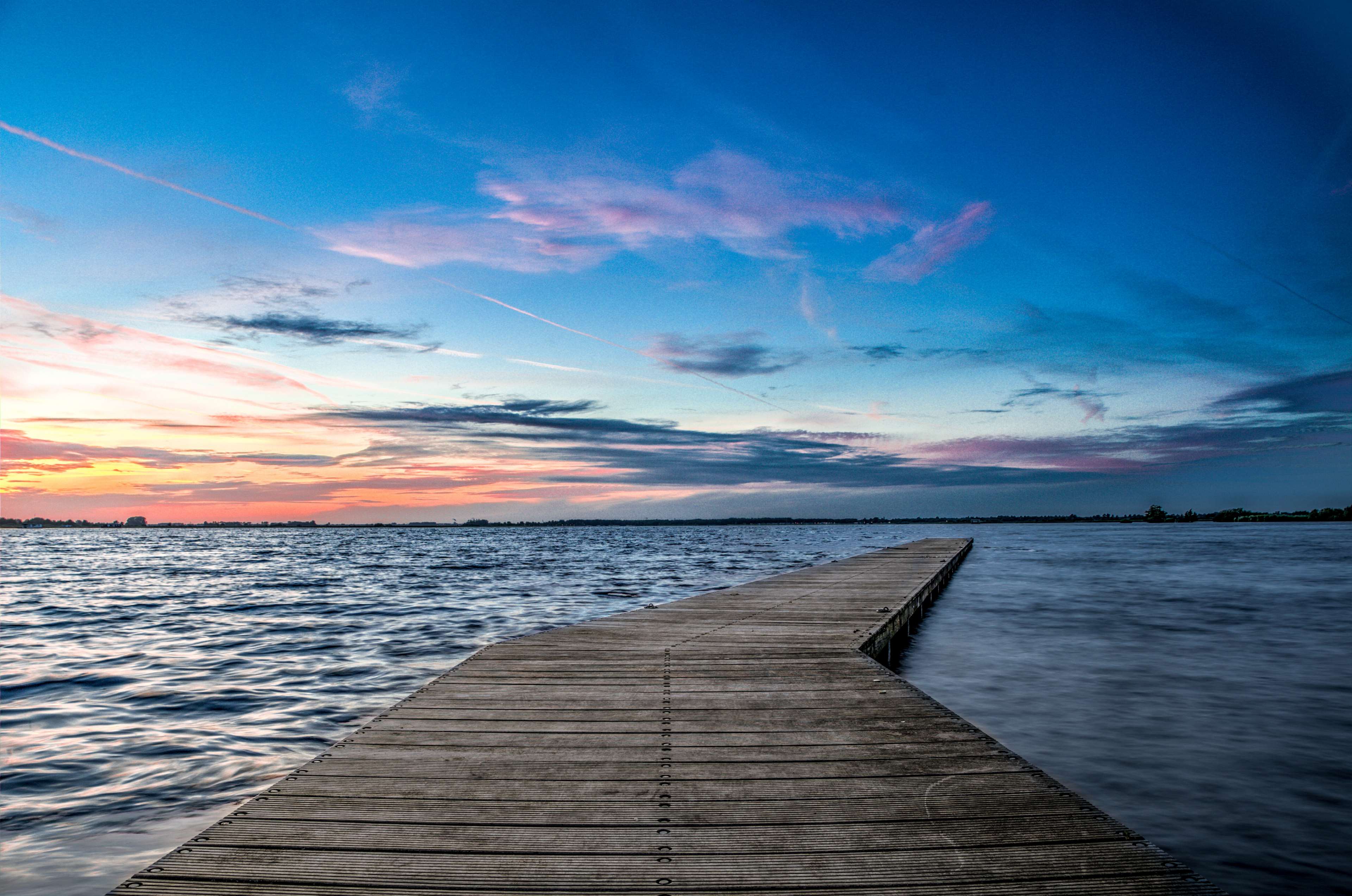Wooden jetty on a lake at sunset 4K HD Wallpaper