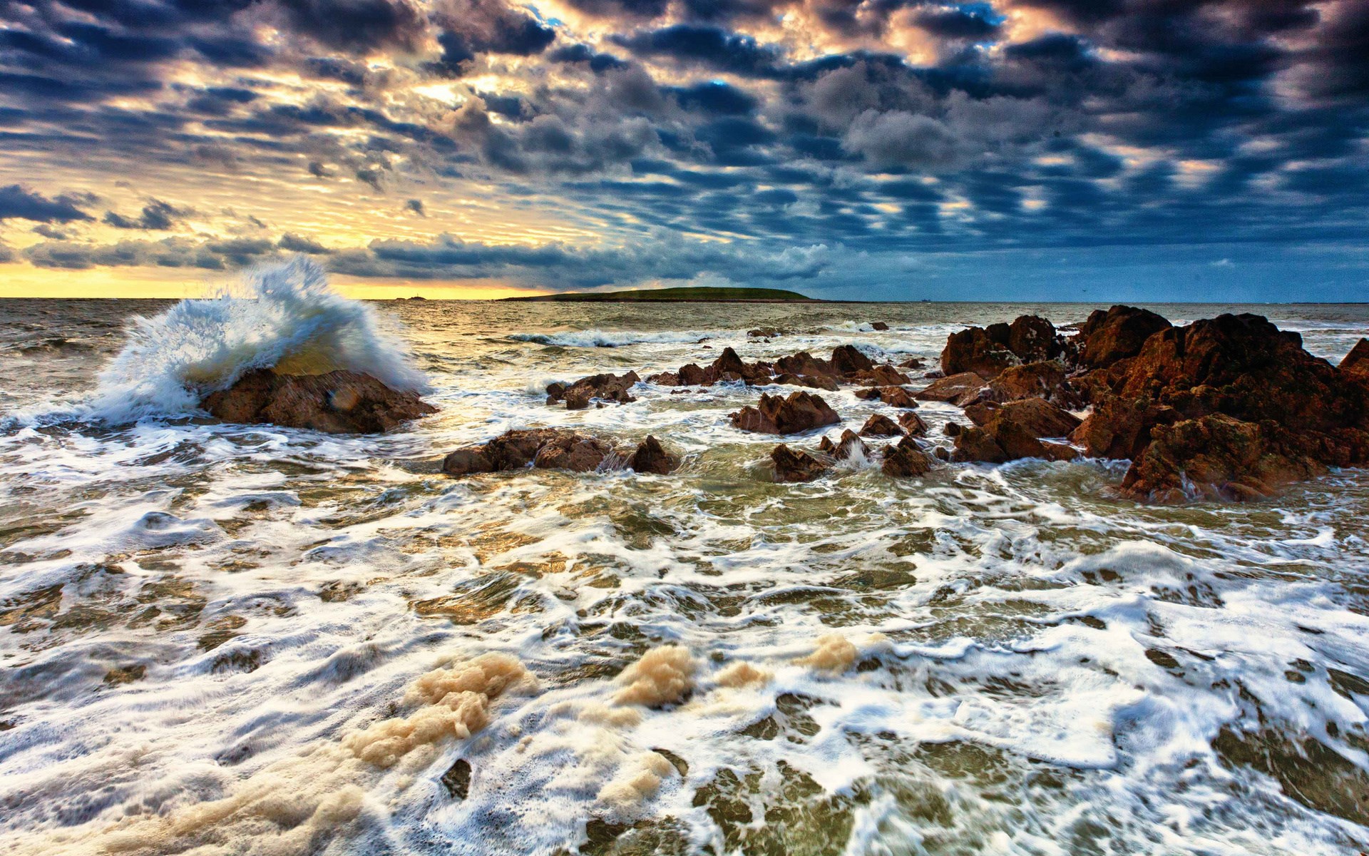 Waves crashing on rocky shore at sunset HD Wallpaper