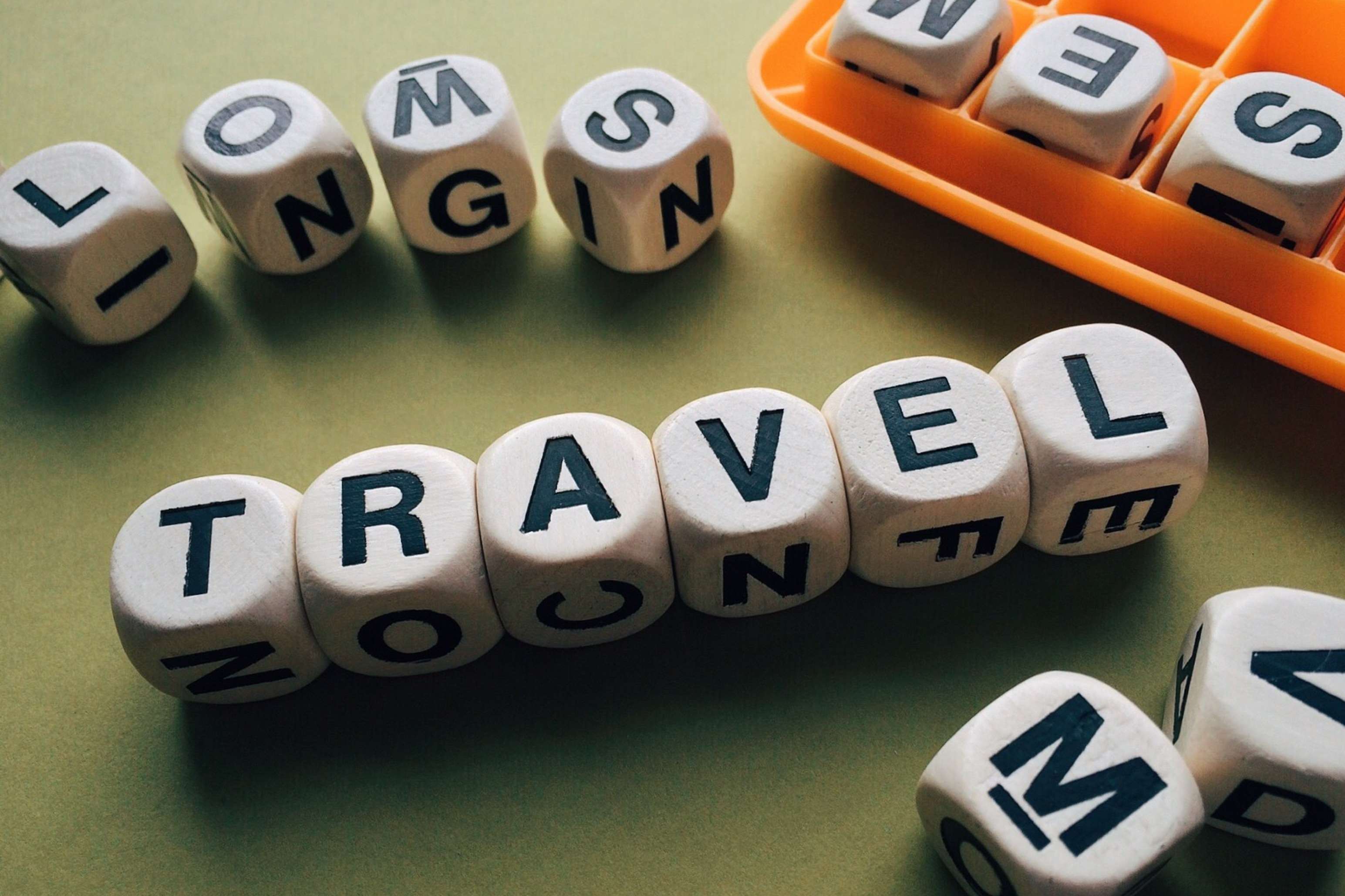 Wooden letter dice spelling TRAVEL and LONGING HD Wallpaper