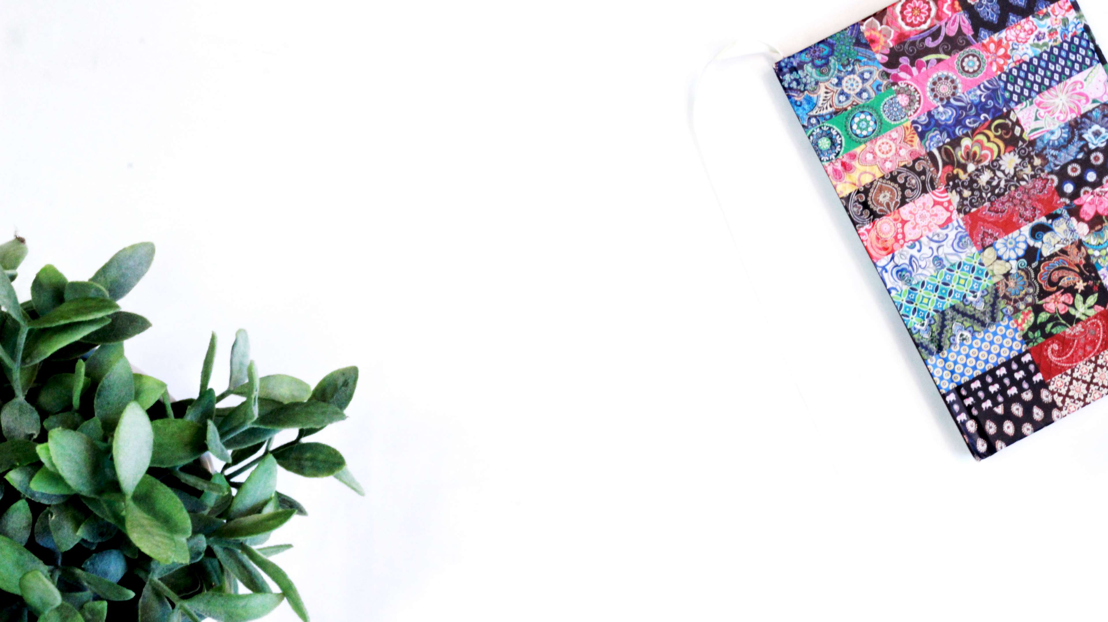 Flat lay with greenery and a colorful journal HD Wallpaper
