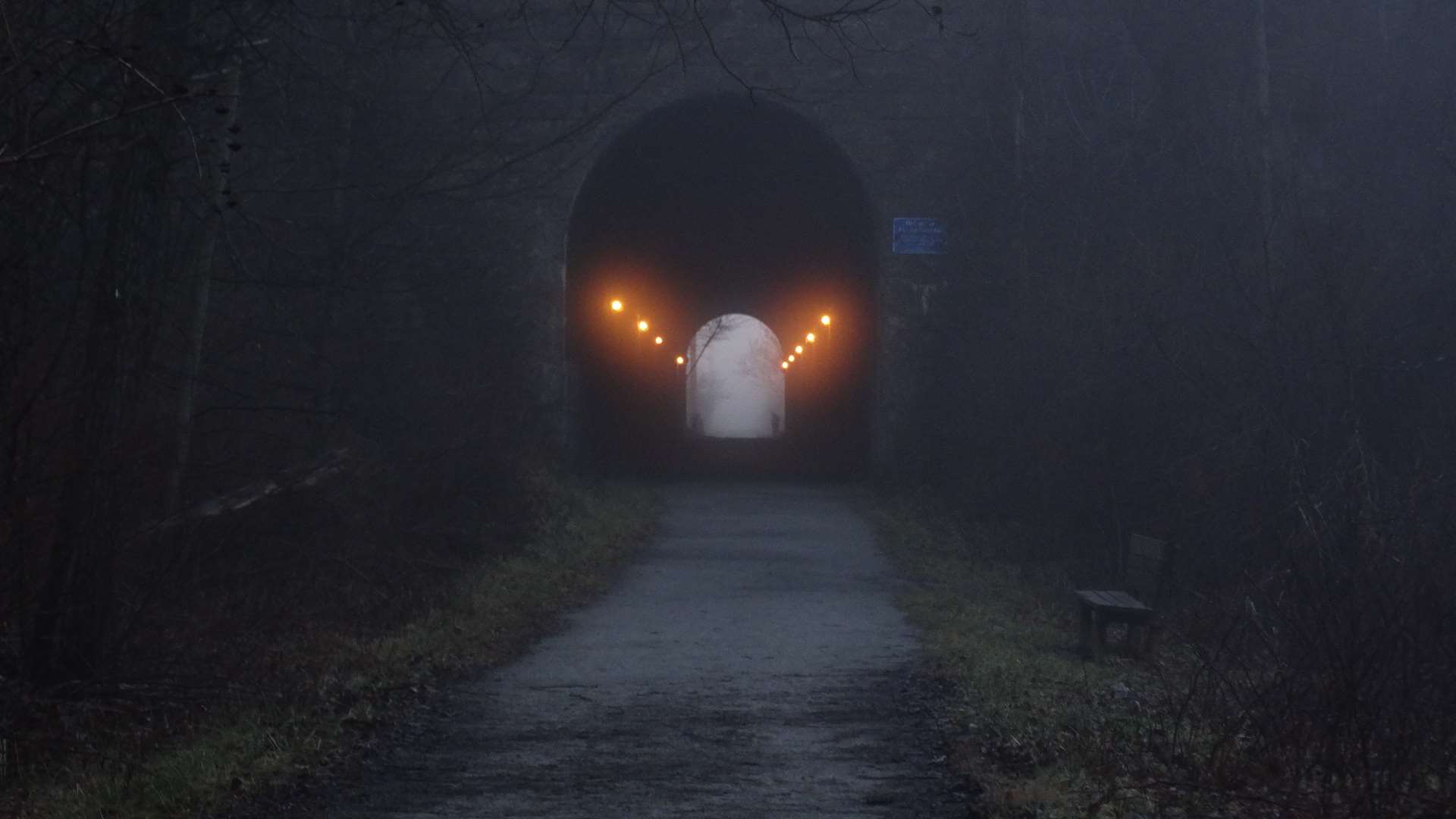 Dark train tunnel with lights on a foggy morning HD Wallpaper