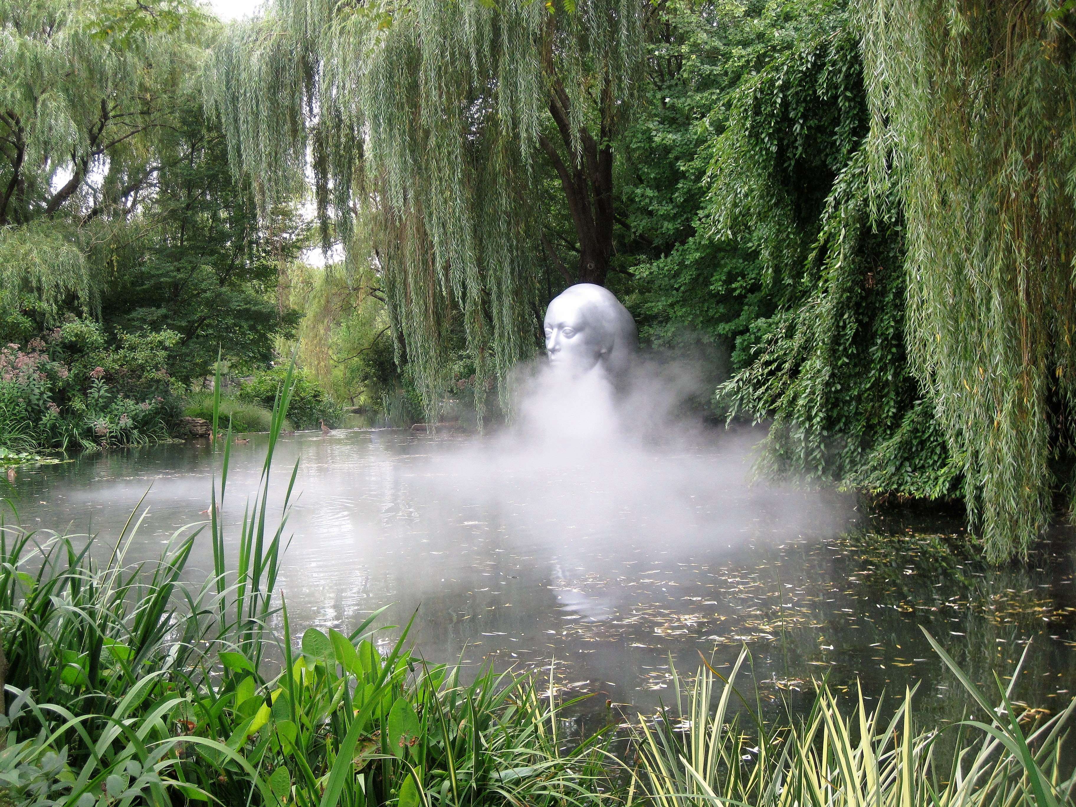 Sculpture of a woman's head emerging from mist in a pond at Grounds For Sculpture HD Wallpaper