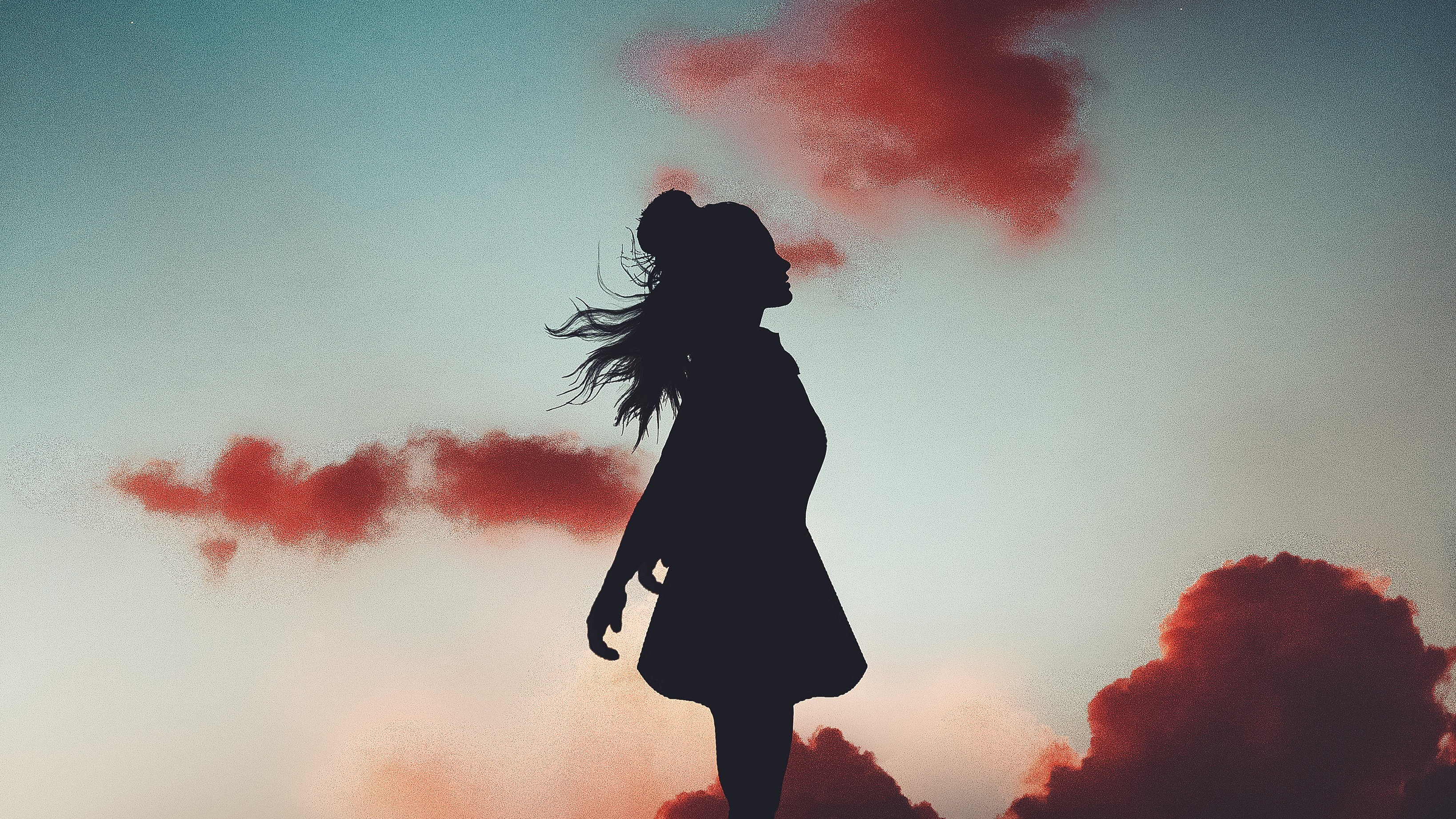 Silhouette of a woman against a colorful sky with clouds HD Wallpaper