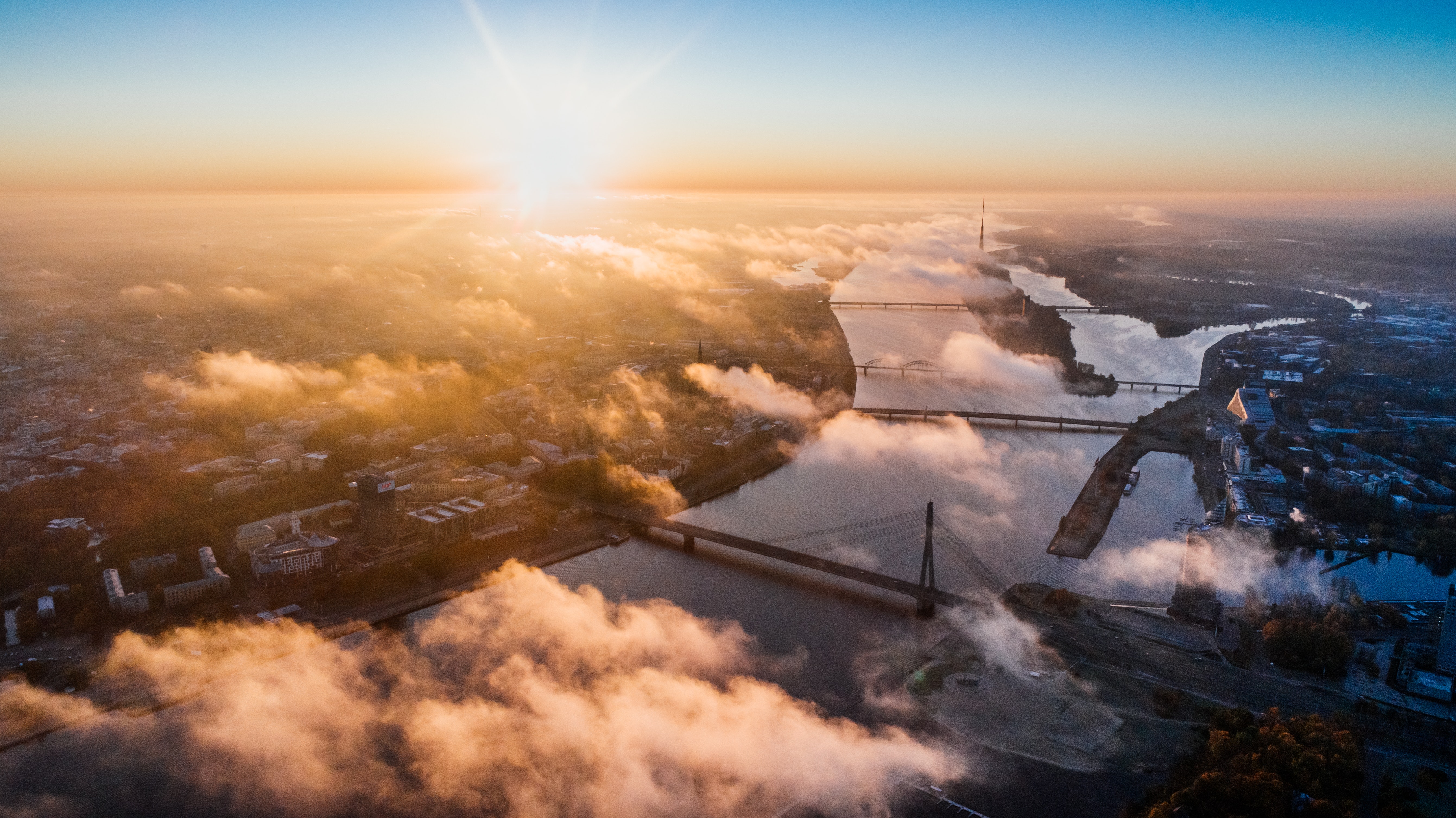 Aerial view of Riga, Latvia at sunrise with clouds HD Wallpaper
