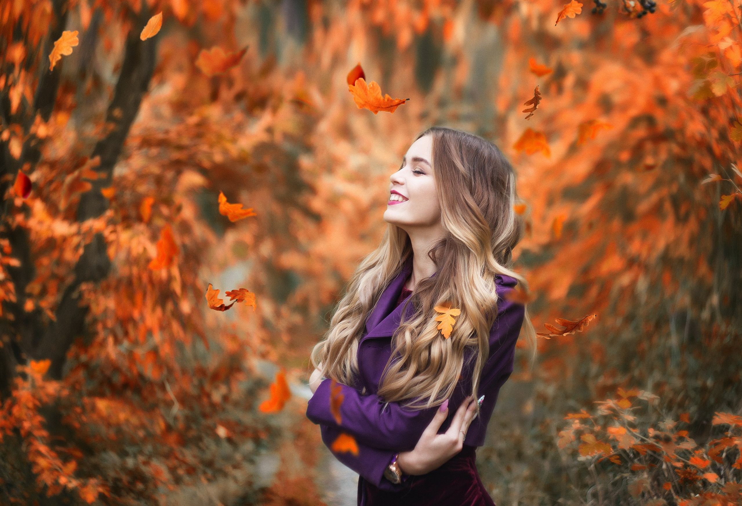 Smiling Blonde Woman with Long Hair in Fall Leaves HD Wallpaper