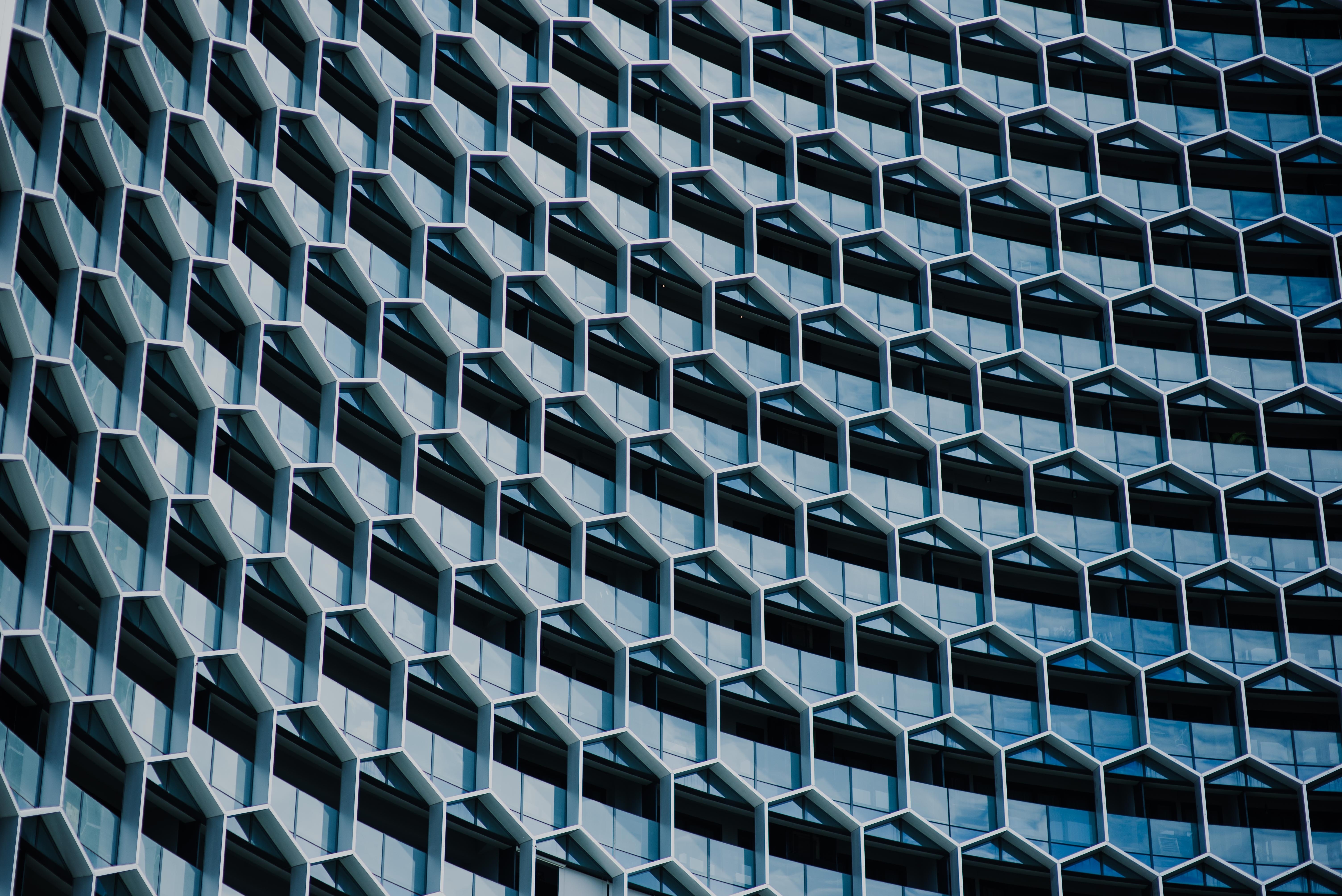 Hexagonal building facade with repeating windows HD Wallpaper