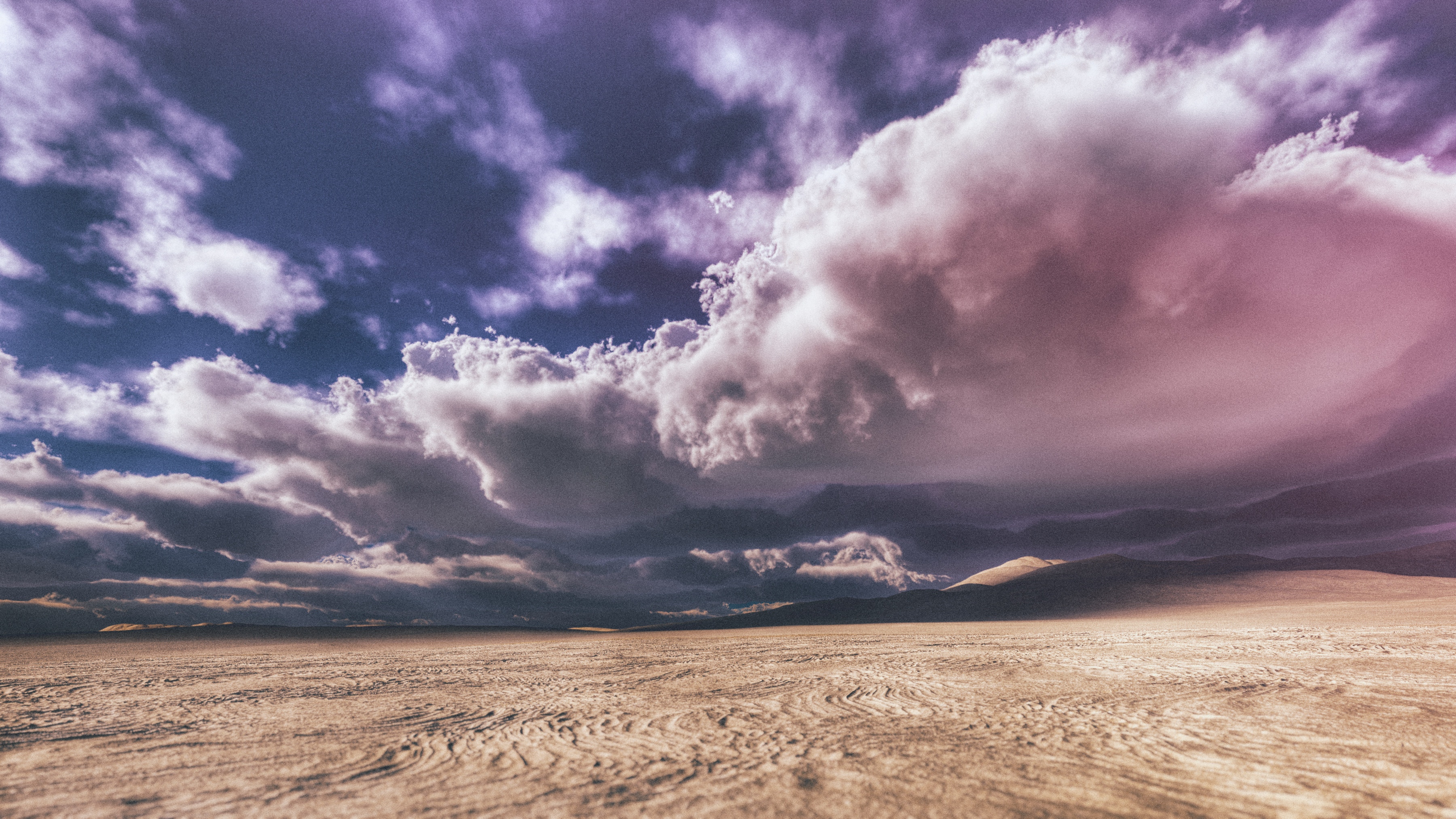 Dramatic clouds over a sandy desert landscape HD Wallpaper