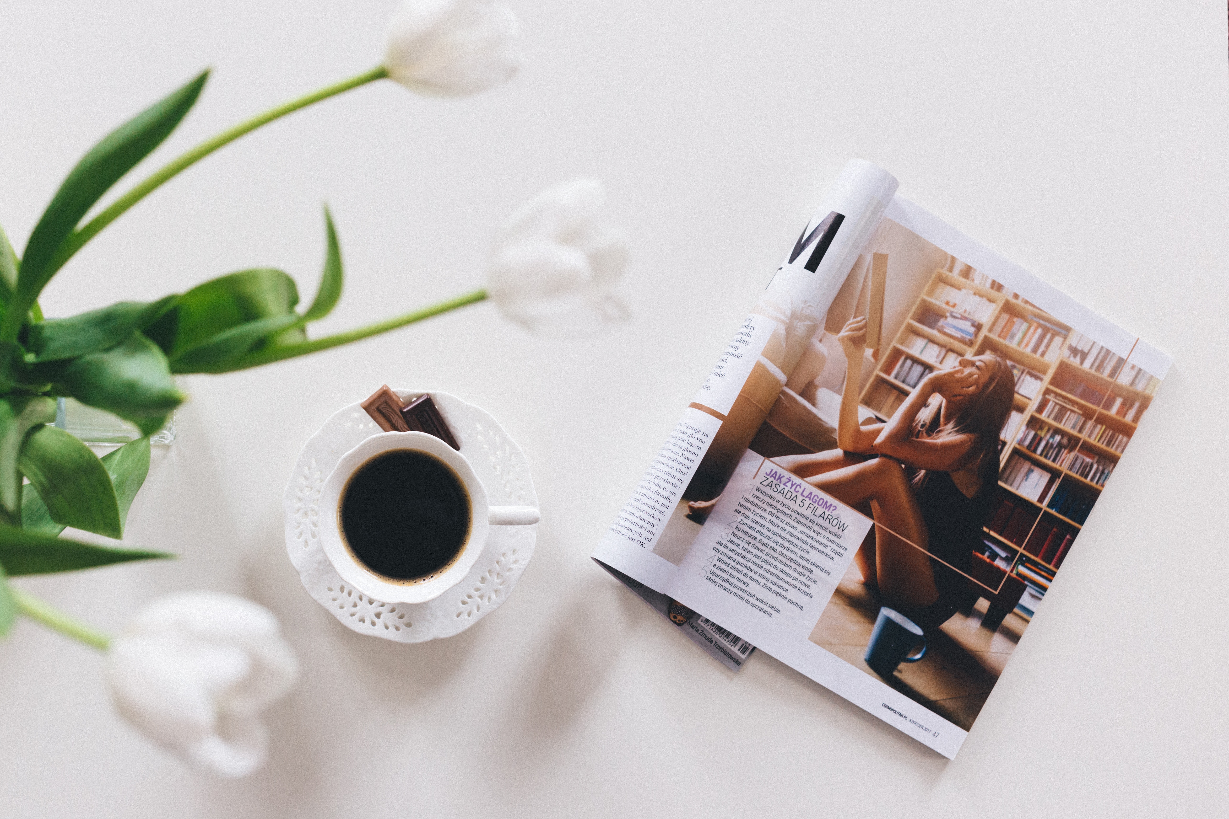 White tulips, coffee cup, and magazine on a table HD Wallpaper