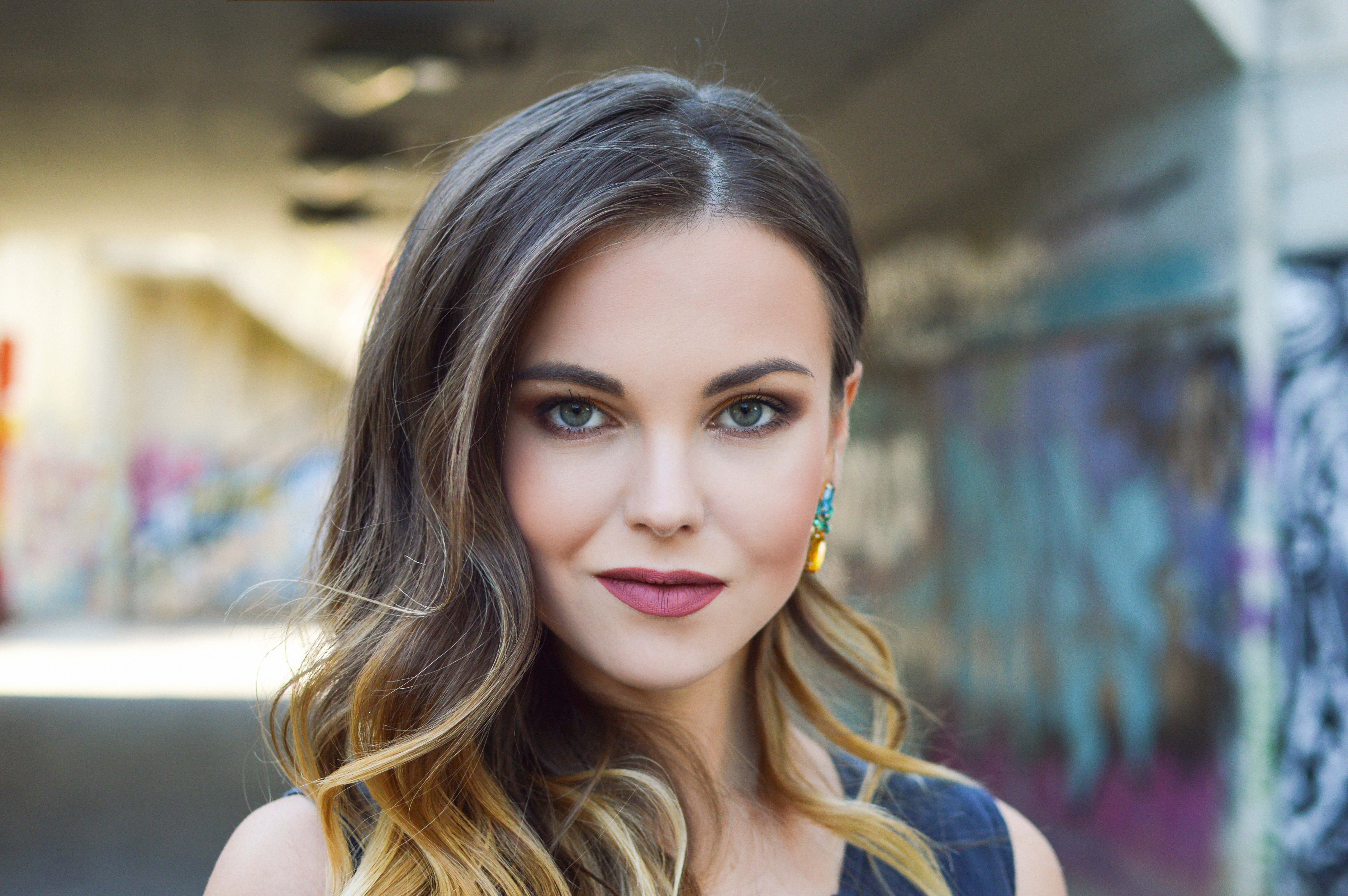 Woman with long brown hair and makeup HD Wallpaper