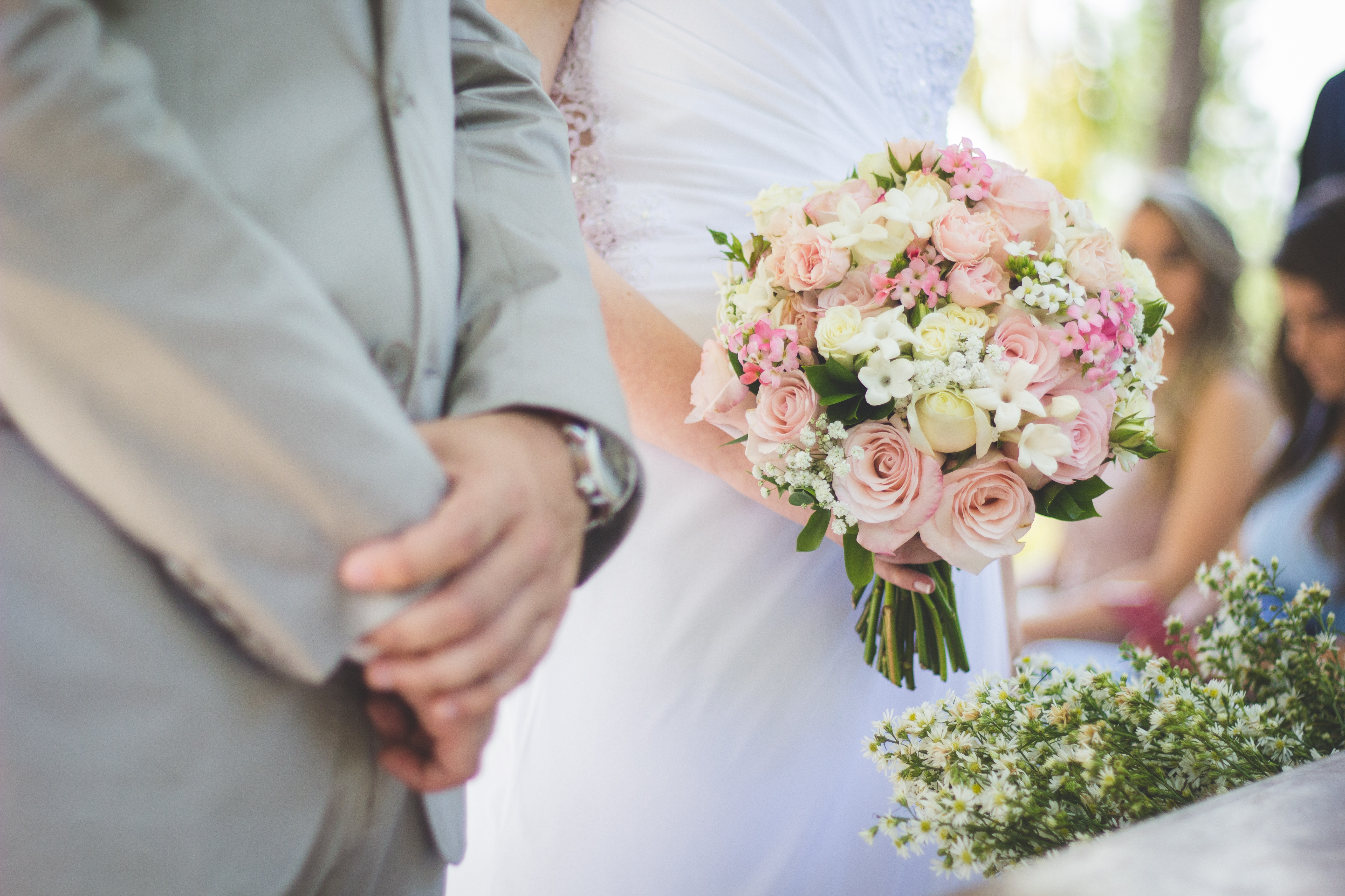 Bride holding a pink and white bouquet at a wedding HD Wallpaper