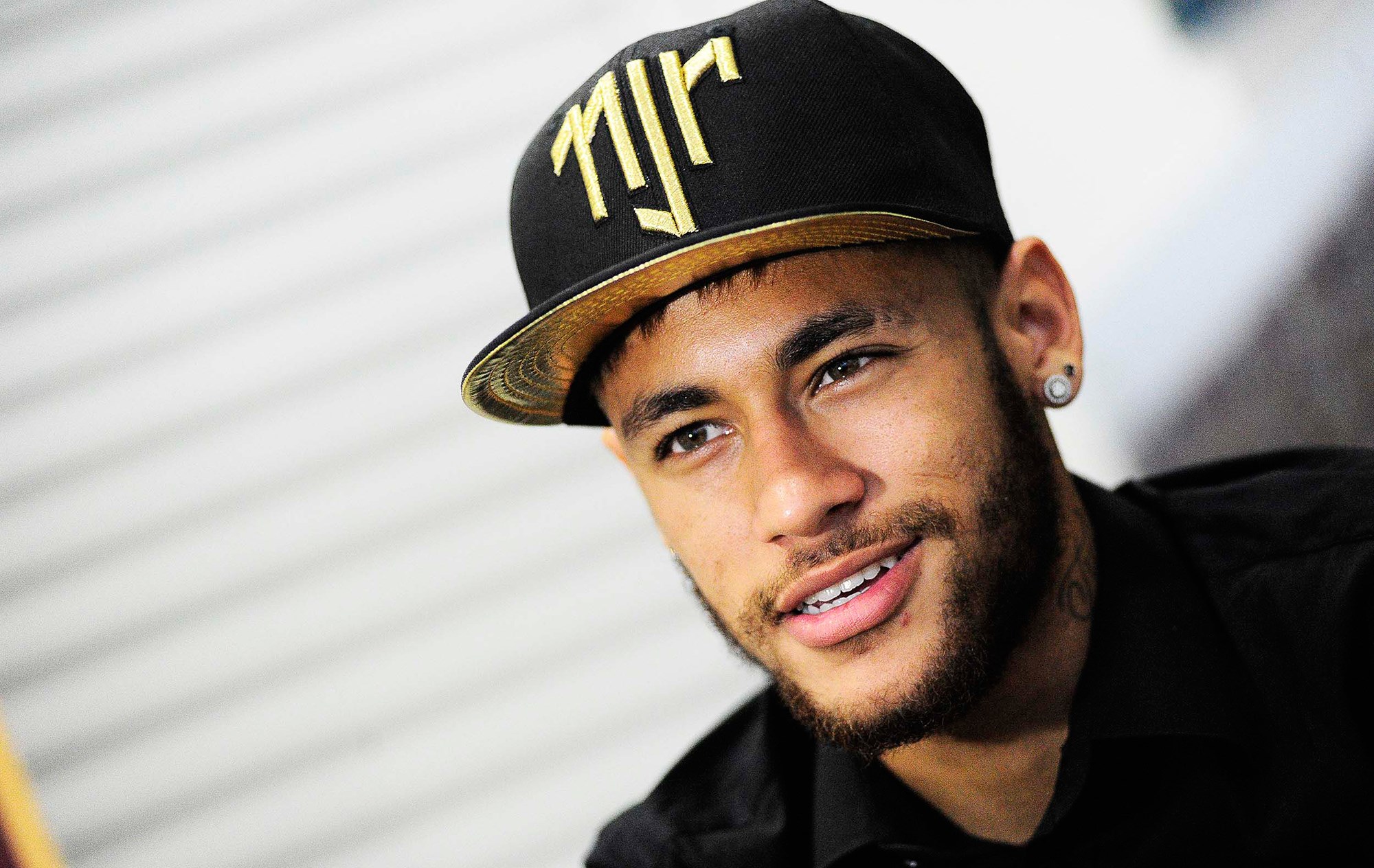 Neymar wearing a black cap with gold logo HD Wallpaper