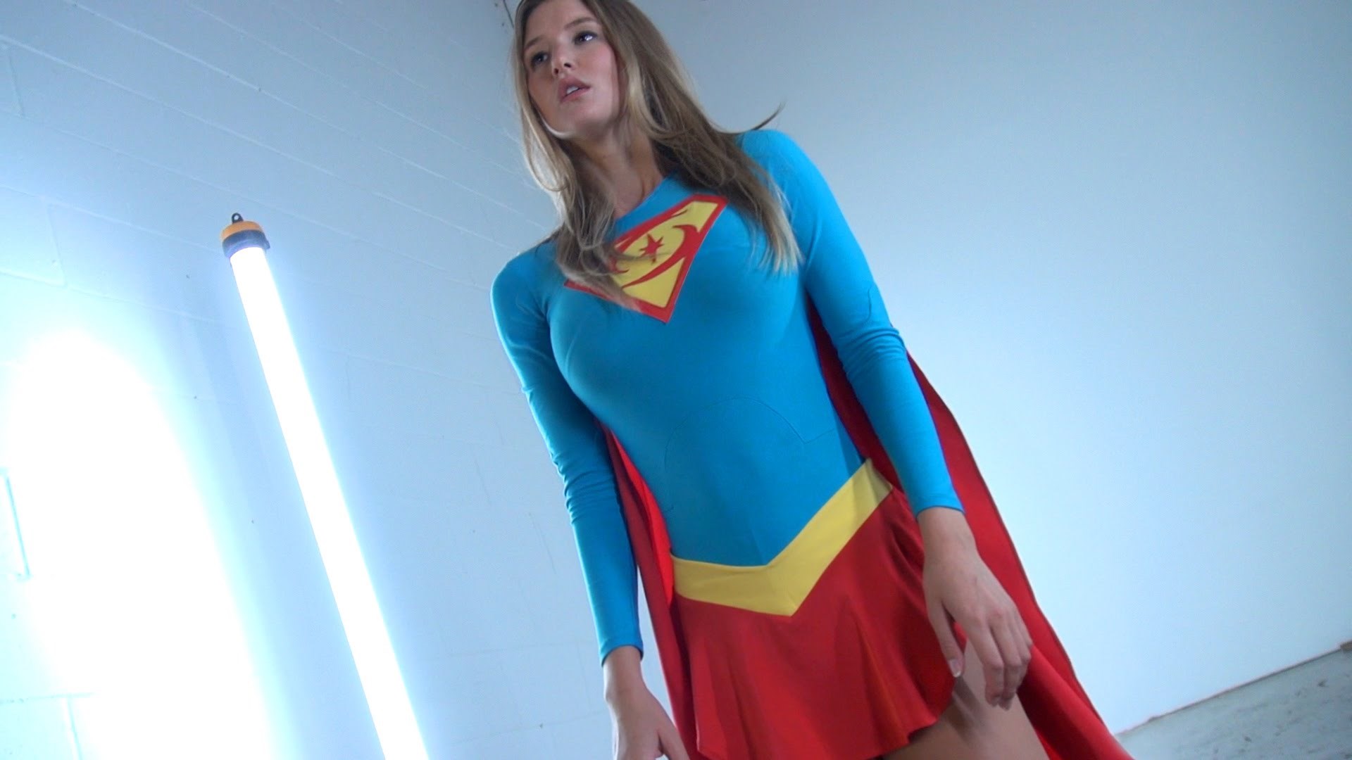 Supergirl in costume with red cape HD Wallpaper