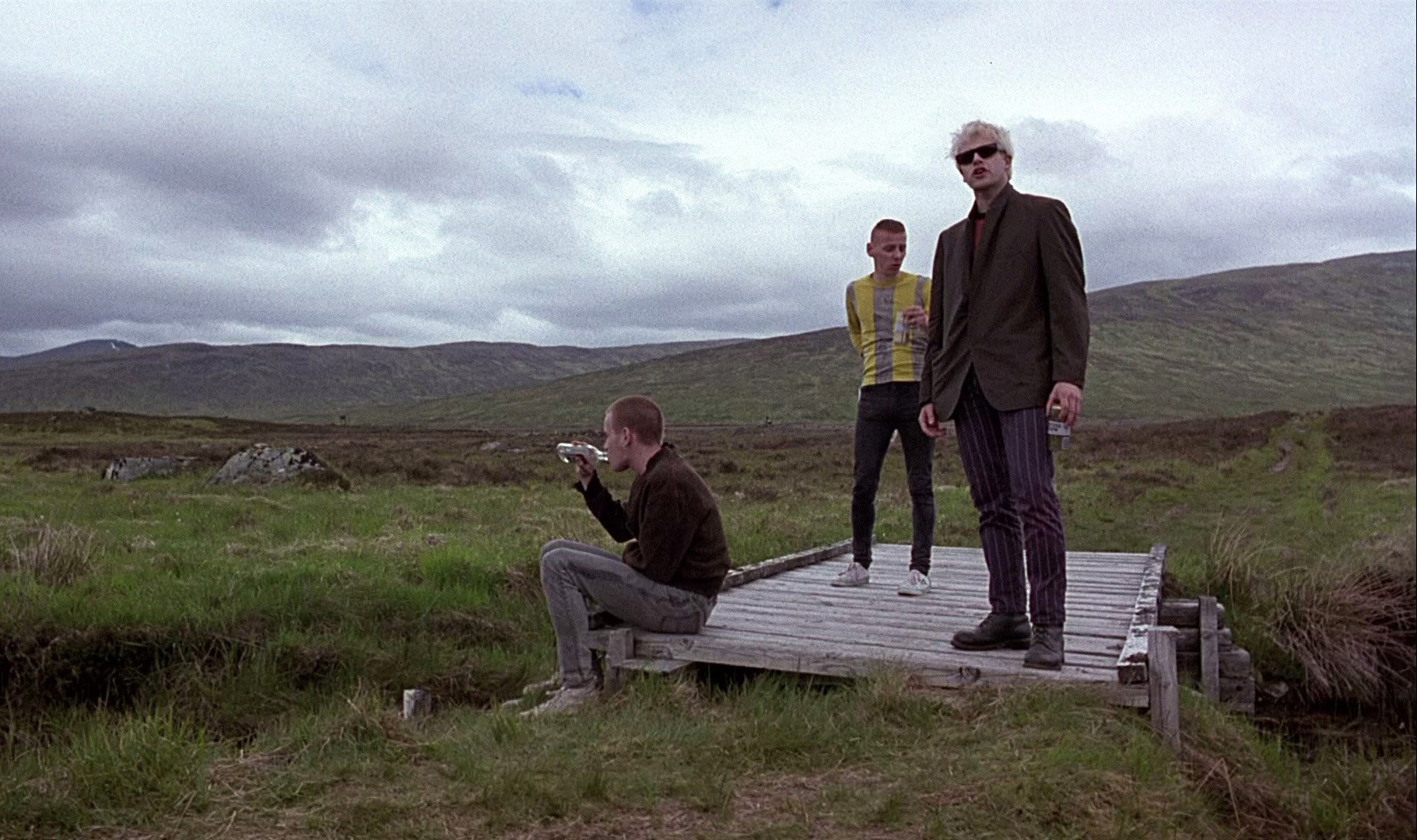 Trainspotting: Three men on a bridge in a landscape HD Wallpaper