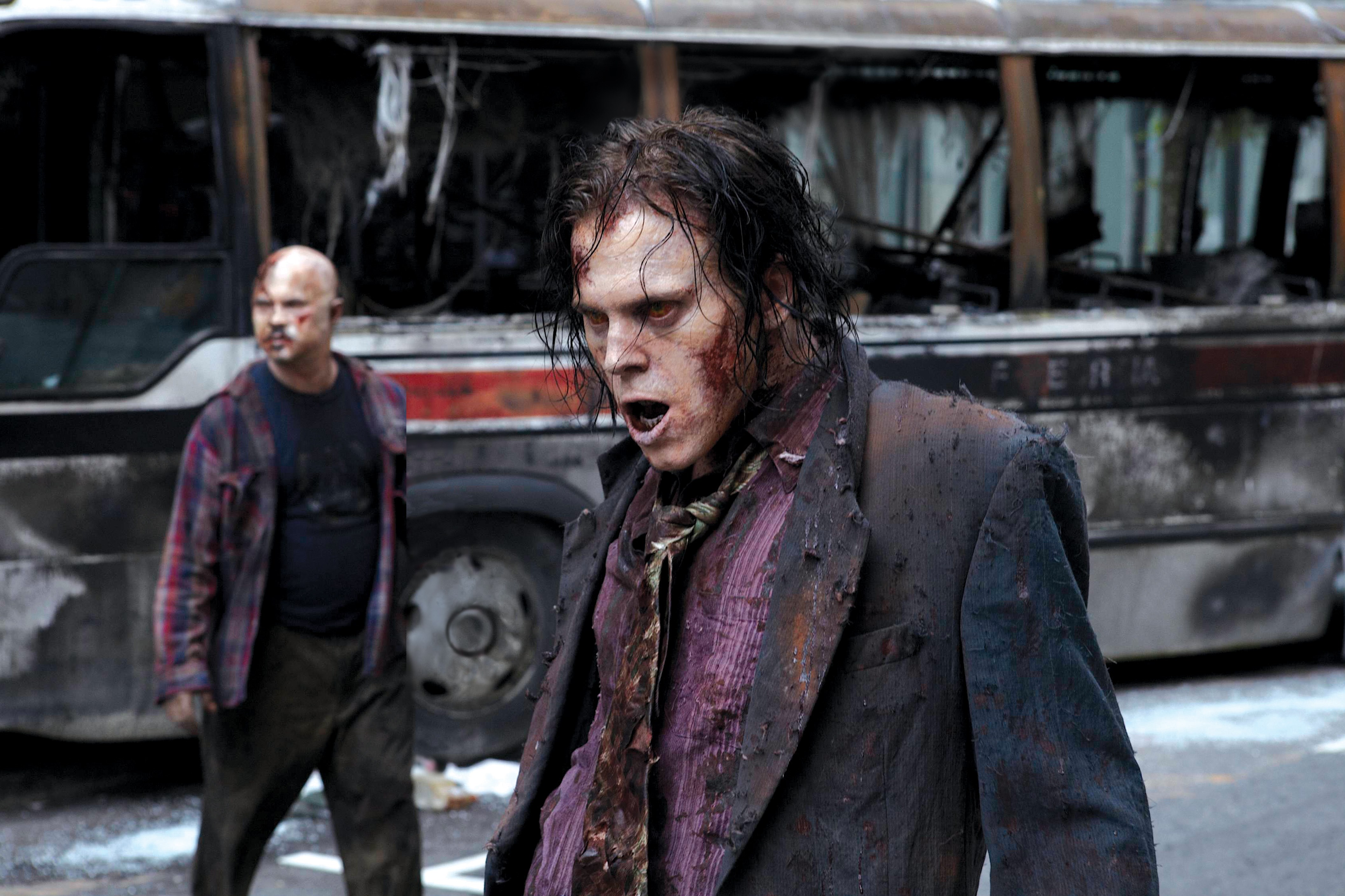 The Walking Dead zombies in front of a burnt bus HD Wallpaper