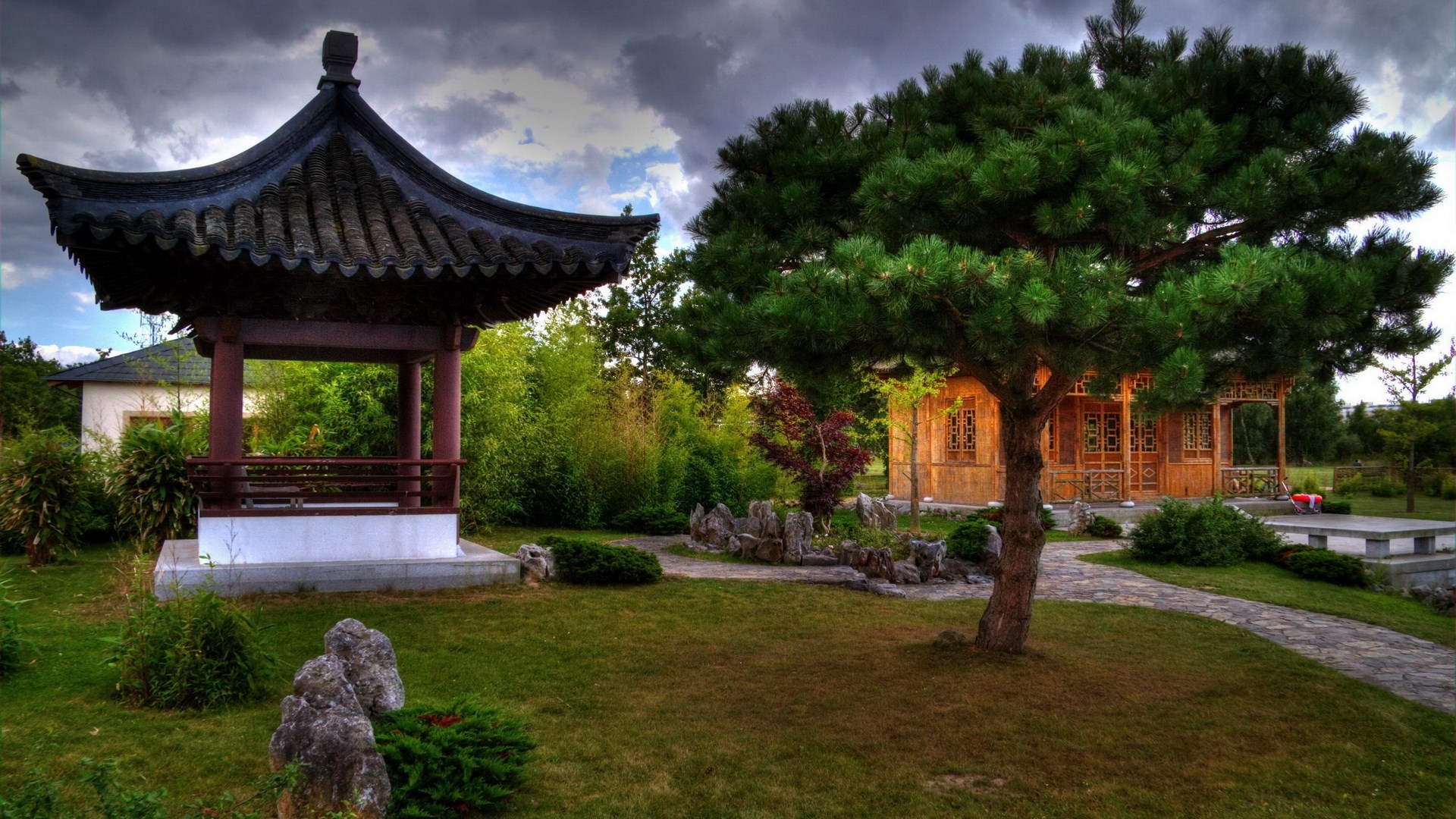Gazebo and building in a garden with a pine tree HD Wallpaper