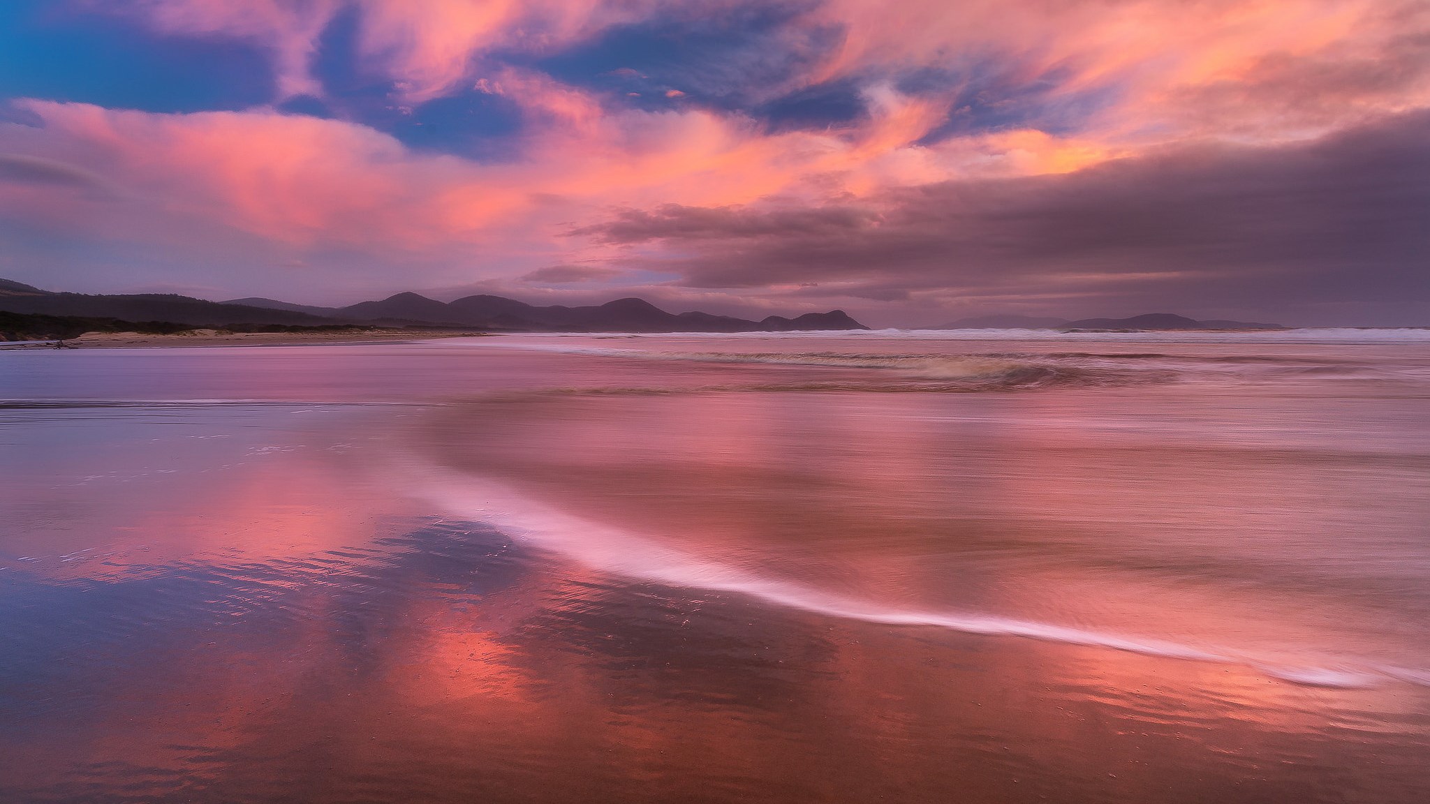 Sunset over a beach with pink clouds HD Wallpaper