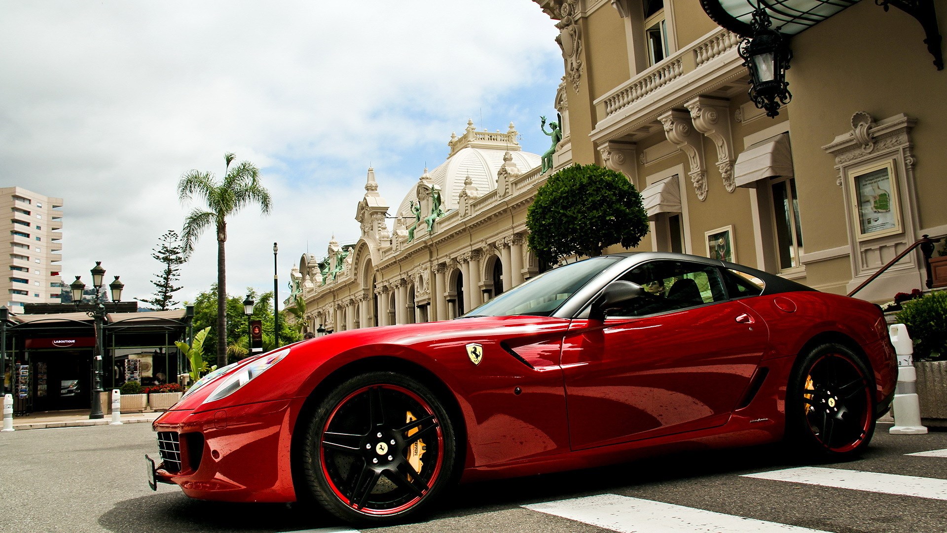 Red Ferrari parked in front of a building HD Wallpaper