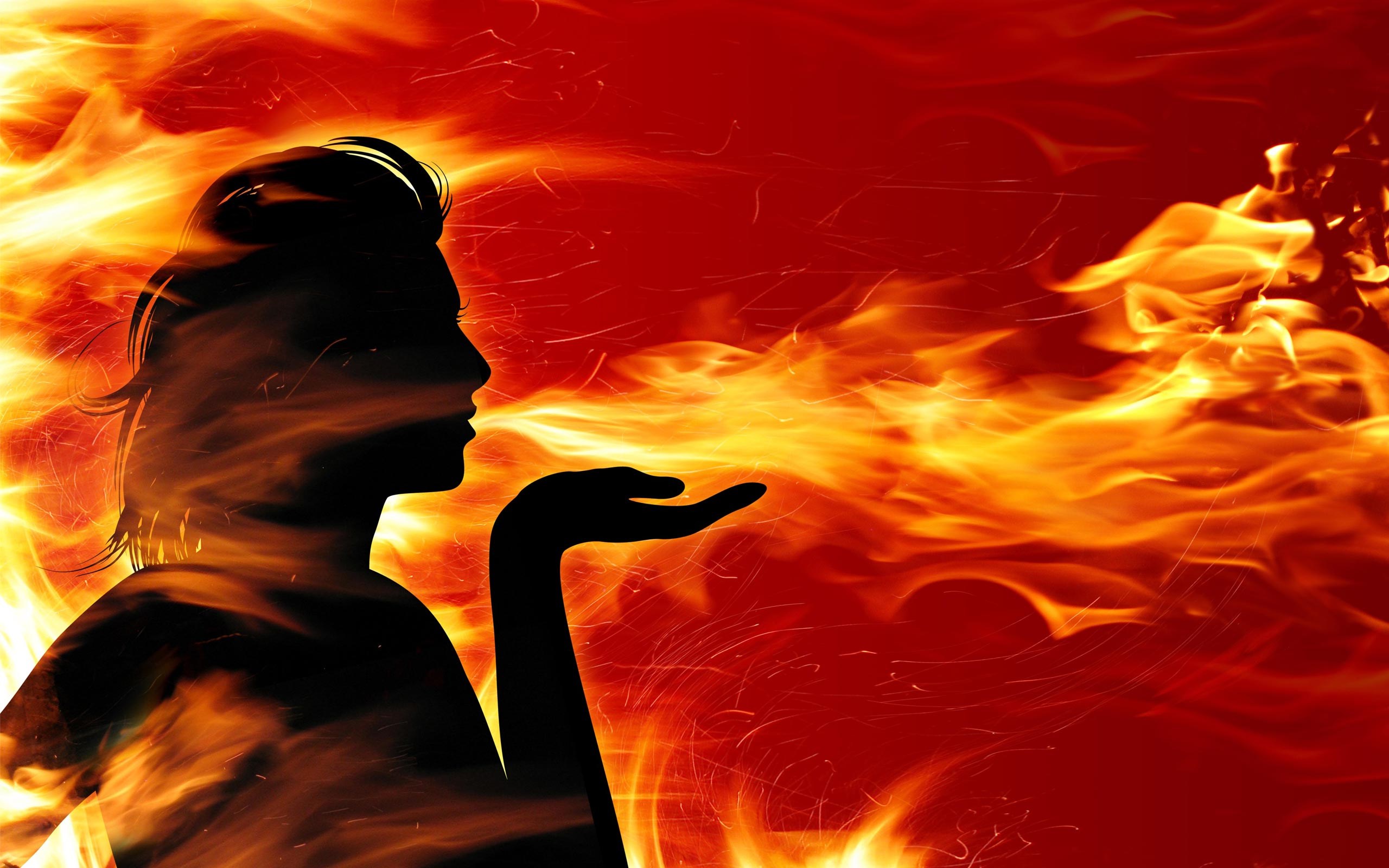 Silhouette of a woman blowing fire HD Wallpaper