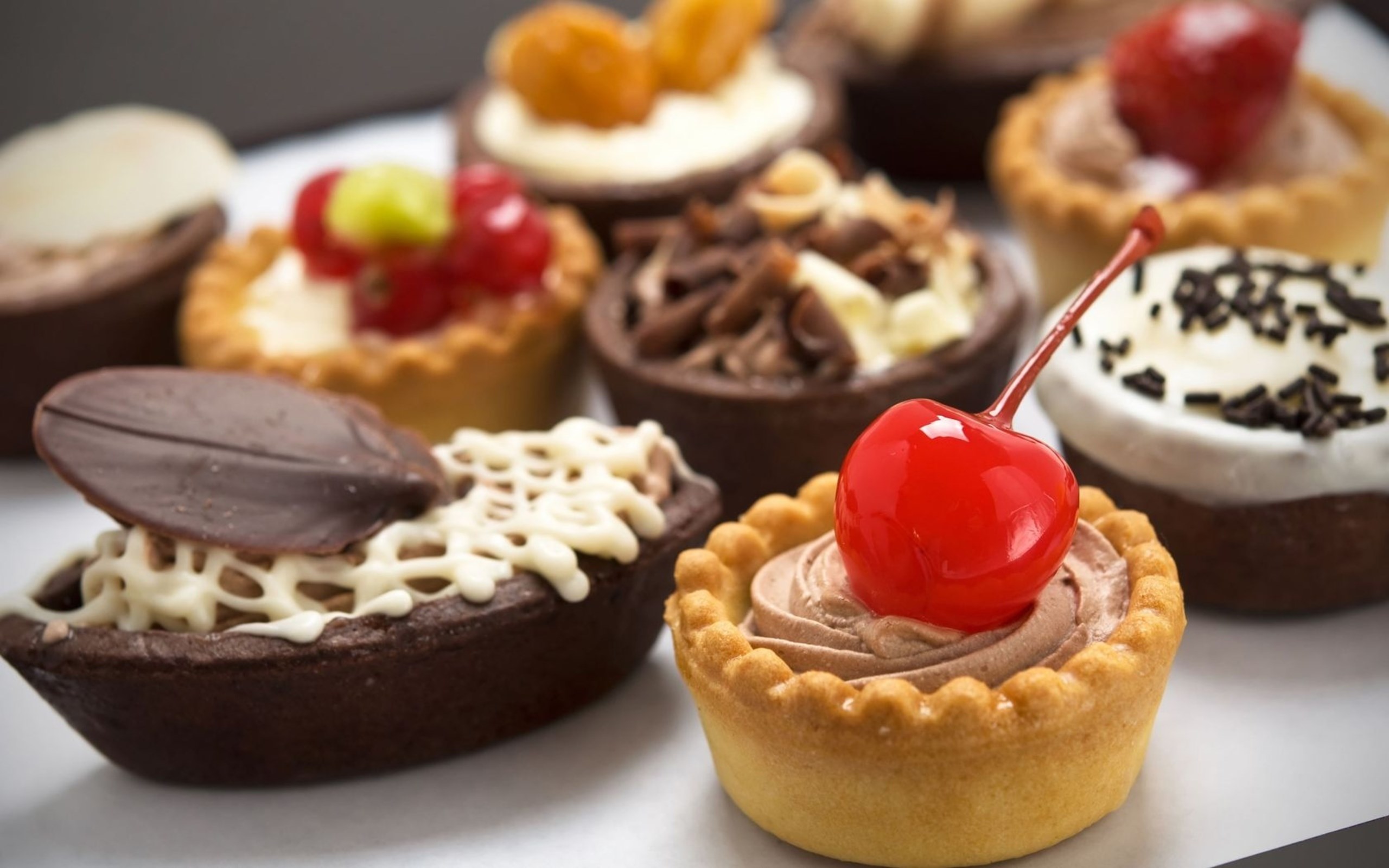 Assortment of decorated sweet tarts and pastries HD Wallpaper