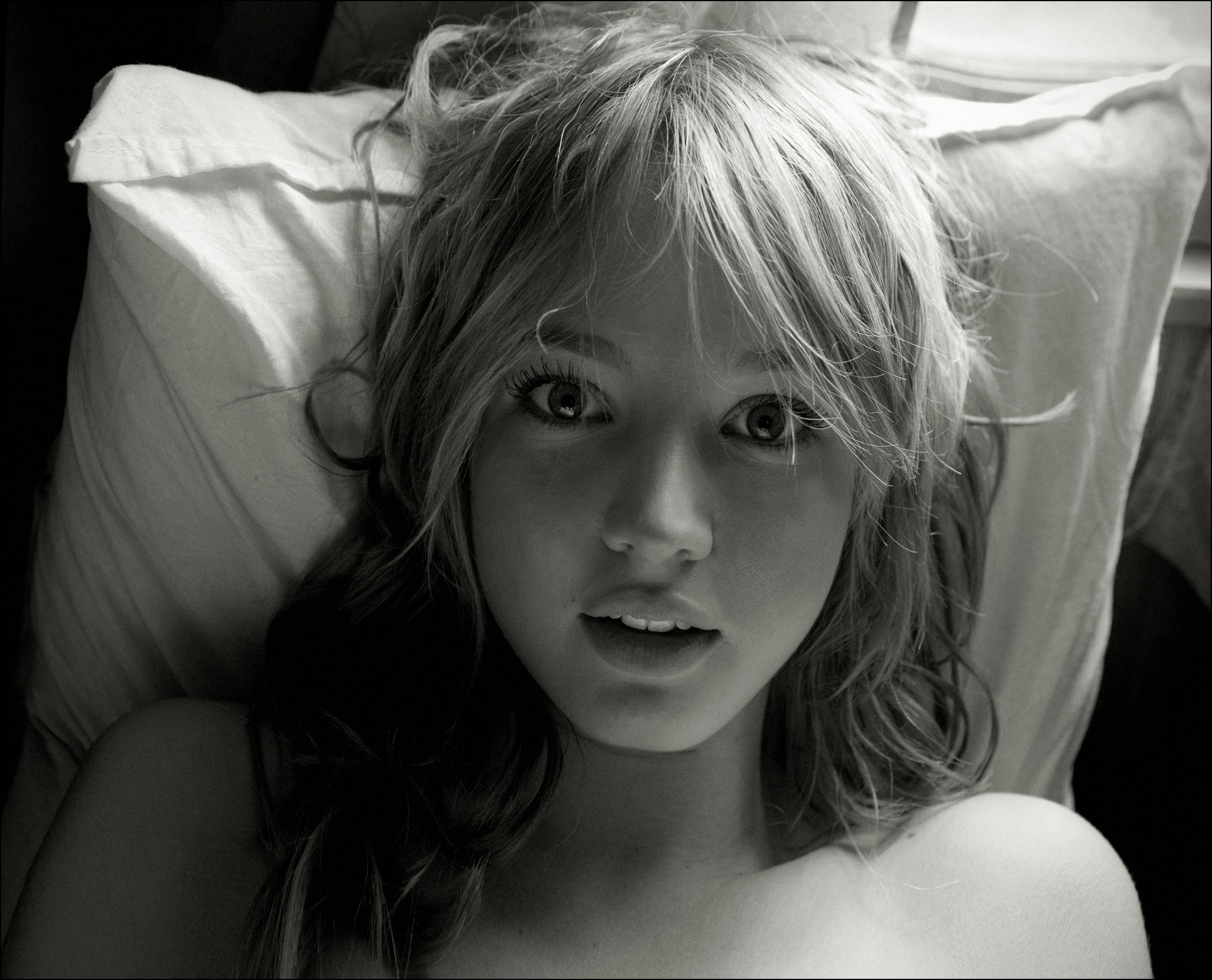 Young woman lying on a pillow HD Wallpaper
